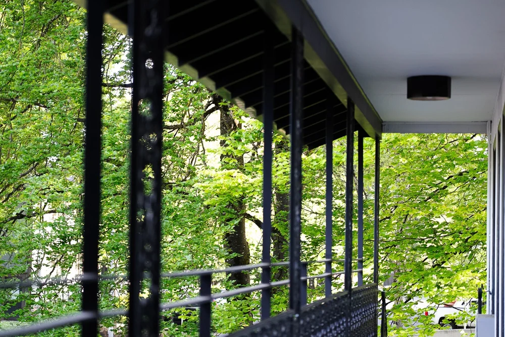 The balcony walkway at The Local, among the trees