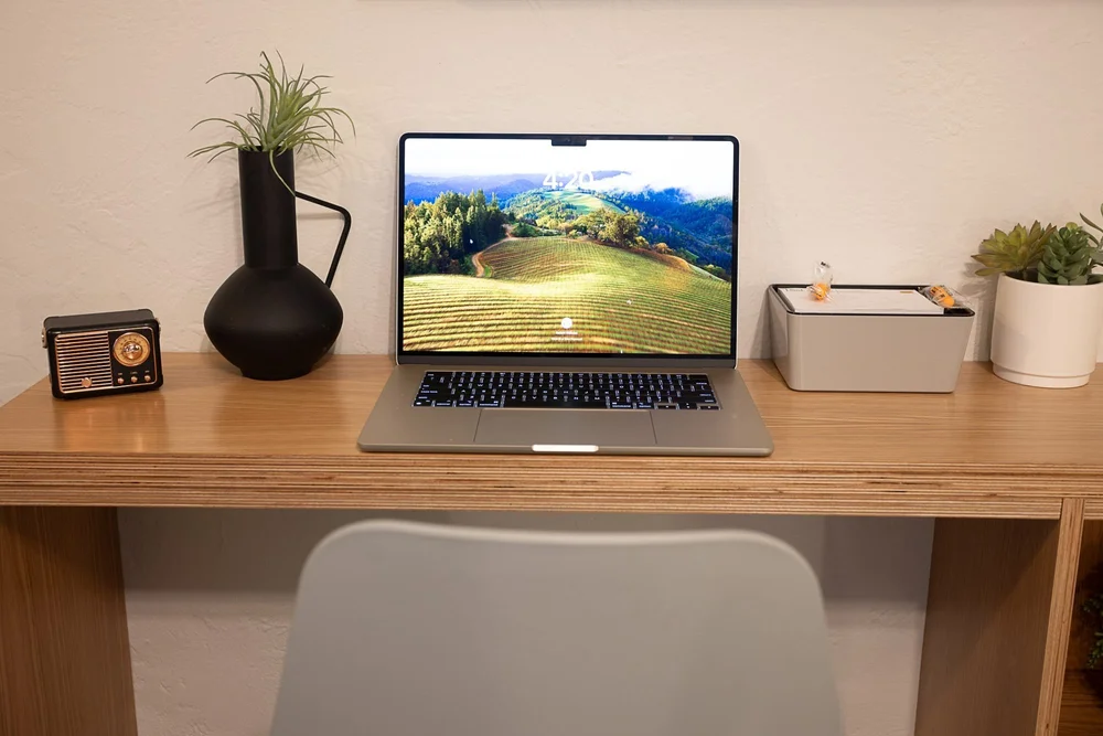 A white oak desk by the window in a Local room
