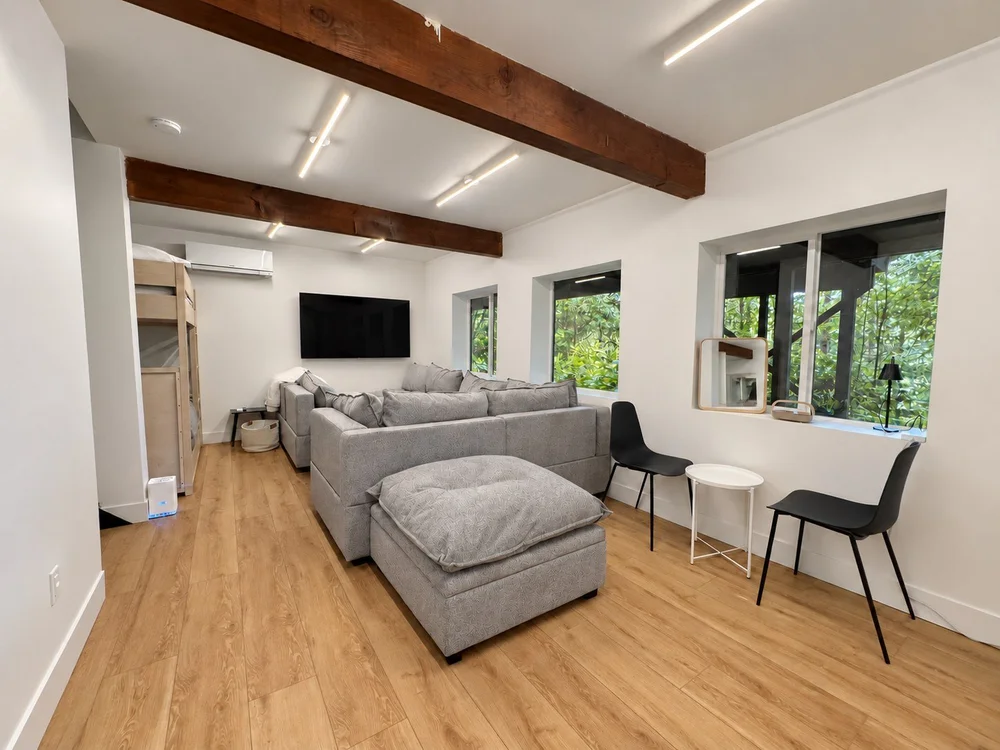 Rec room with an oversized gray sofa pit and a TV