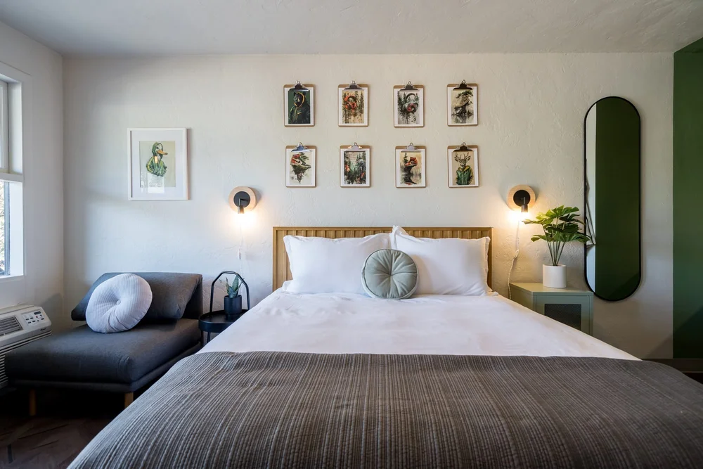 A Local guest room with a white oak bed and curated art