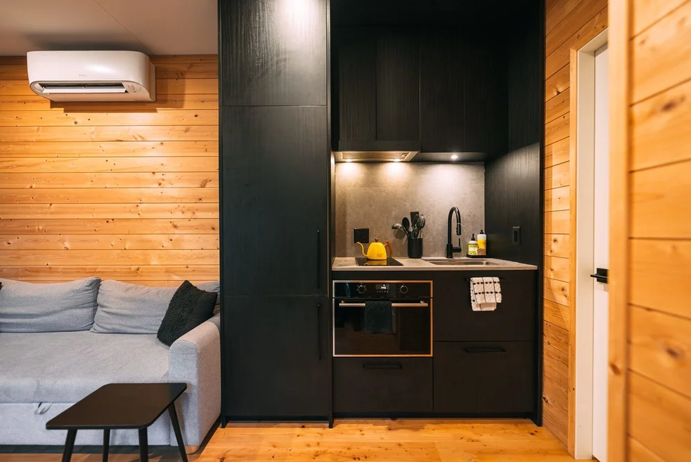 Black kitchen with an oven and induction cooktop