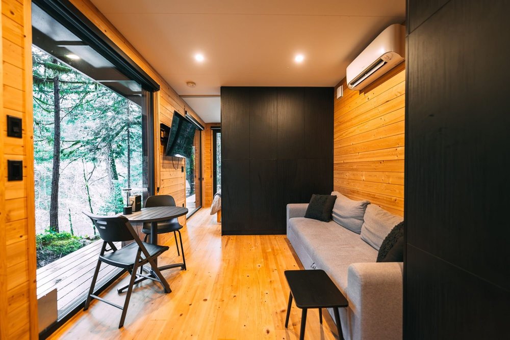 Living room with a sofa and floor-to-ceiling windows over the river