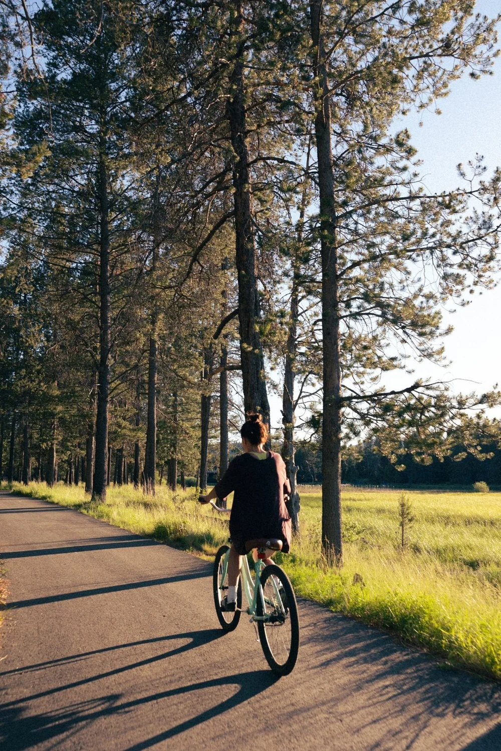 Riding a cruiser along a Sunriver bike path through the pines