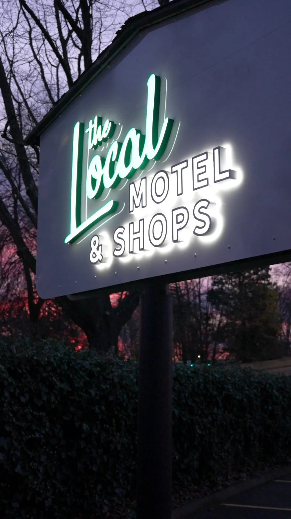 The Local Motel + Shops neon sign at night