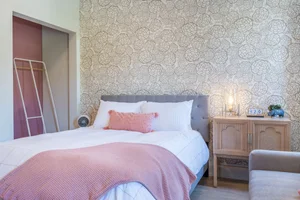 The BoHo suite bed with a pink throw