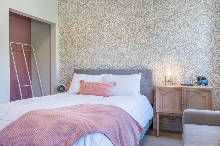 The BoHo suite bed with a pink throw