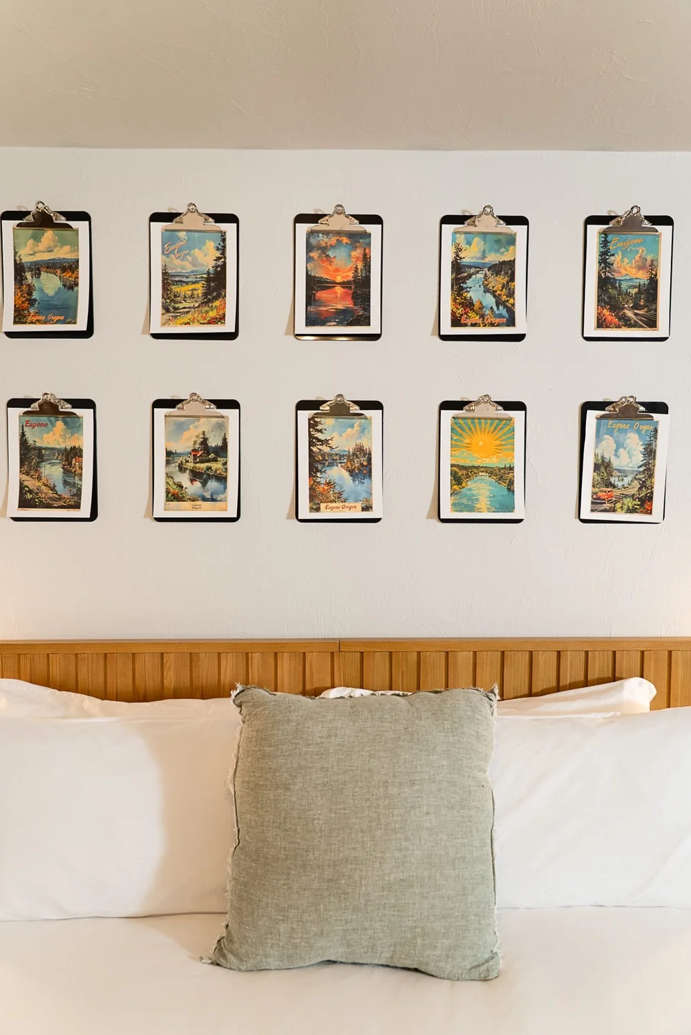Curated PNW art prints above the bed