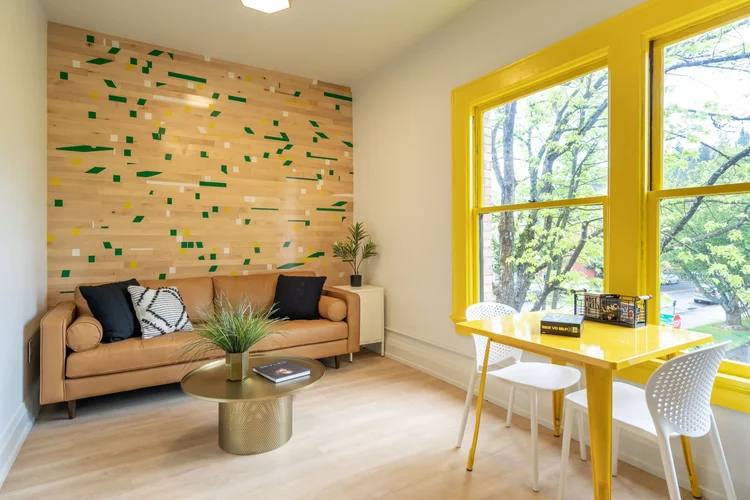 The Collegiate suite living room with a yellow window frame