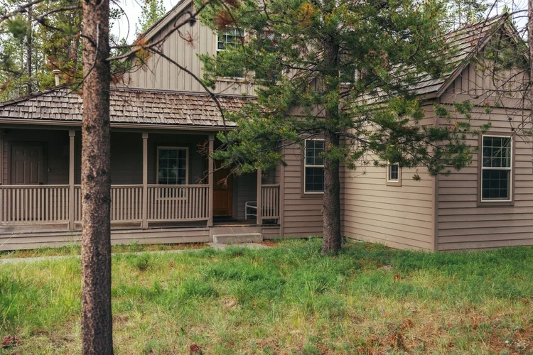 The Sunriver Home front porch among the pines