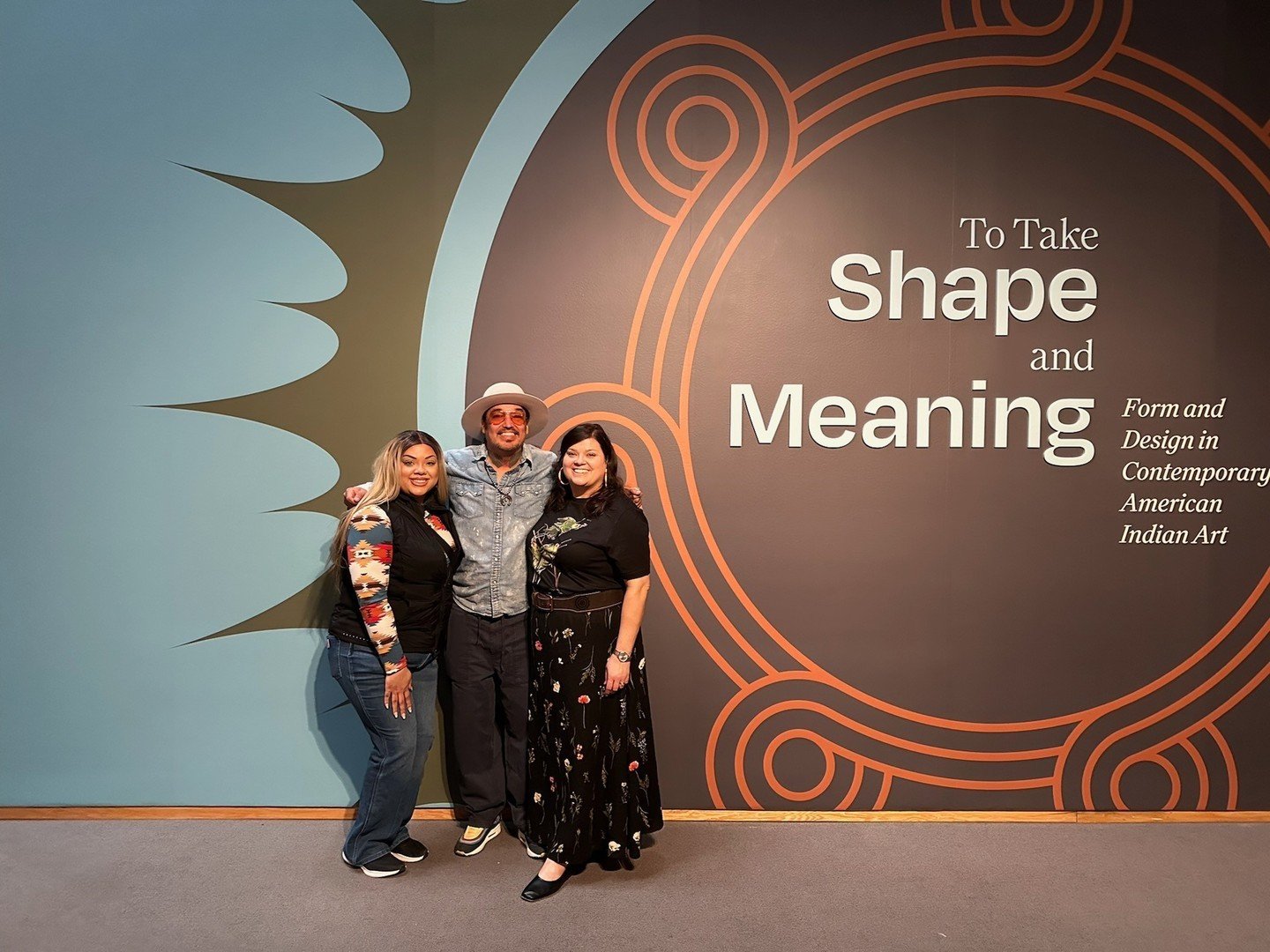 @nancy.fields, Guest Curator of the To Take Shape and Meaning exhibit standing at the exhibit entrance with friends ✨️⁠
⁠
L A Deer Apparel is honored to be included in this exhibit, which features works by 75 Indigenous artists from over 50 tribes th