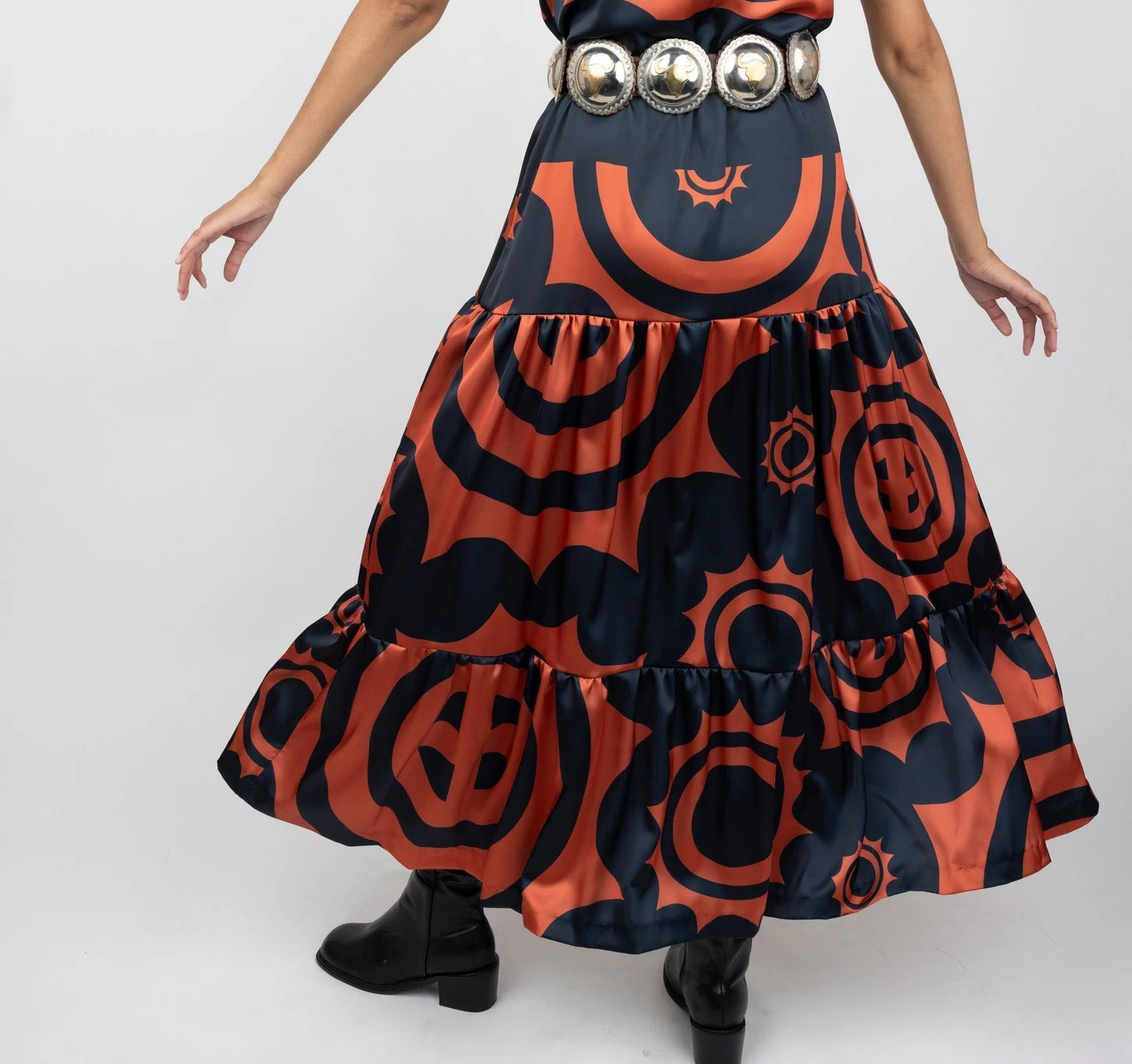 Meet the Winter Copper Maxidress ❄️☀️⁠
⁠
Made to order on Mvskoke Territory, this dress features an elastic waist and button closures. Made from silky Monaco Poly fabric and printed with large scale Sun Circles, it feels just as luxurious as it looks