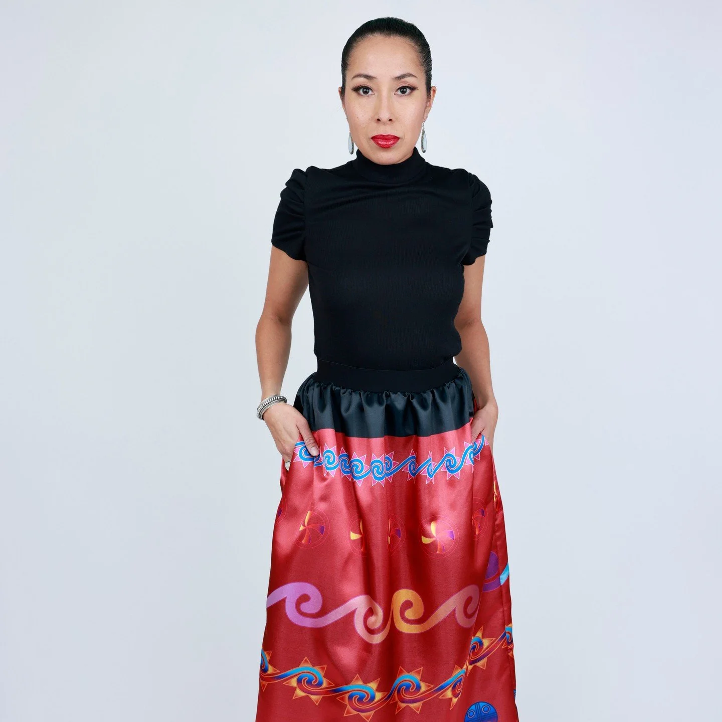 The Southeastern Splendor skirt in classic red from last year's holiday collection ☀️☀️⁠
⁠
Photo: Garett Fisbeck⁠
Model: @haulisioux ⁠
.⁠
.⁠
.⁠
#suncircle #nativeart #mvskoke #buynative #muscogee #indigenous #shopsmall #indigenousart #indigenouswomen