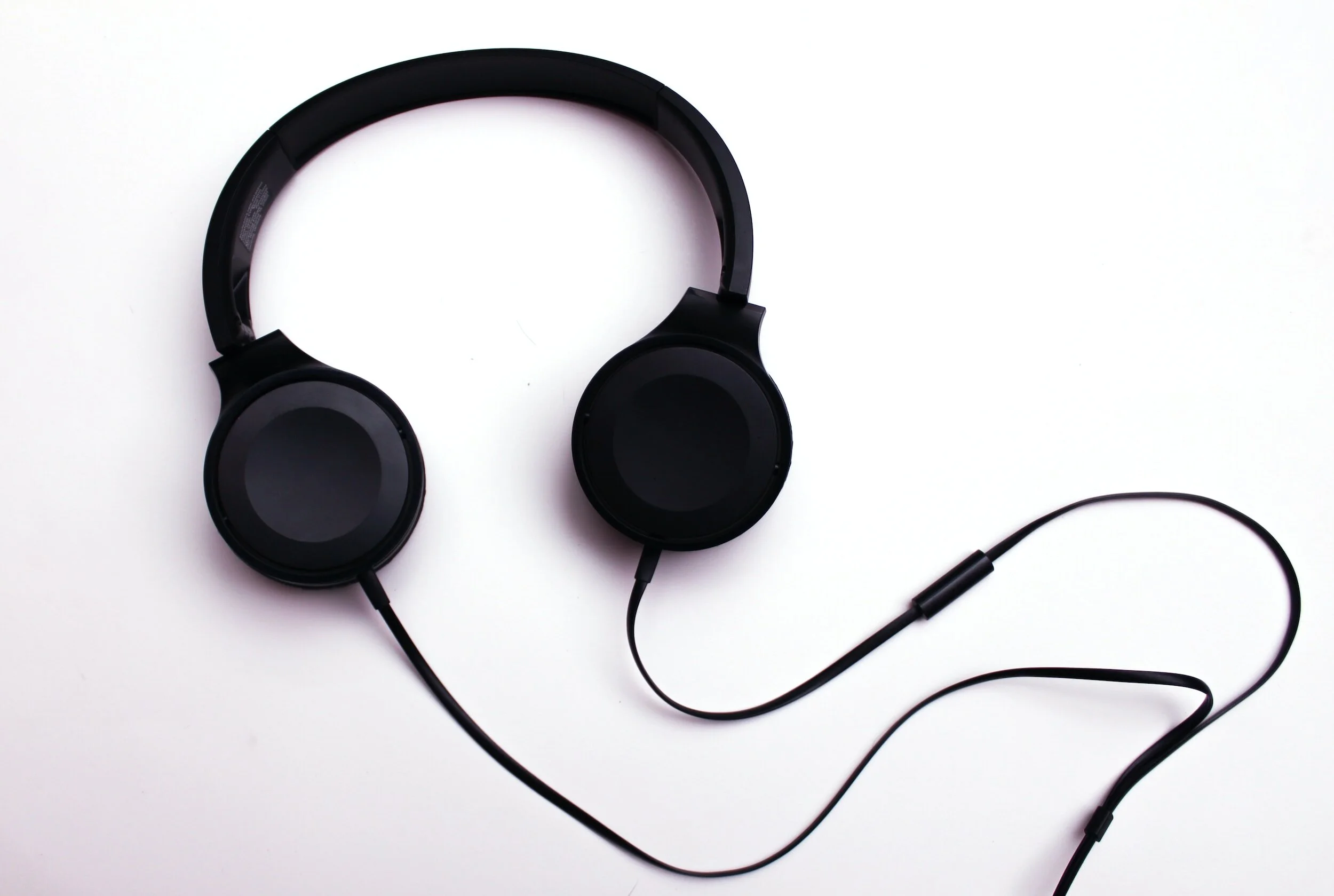 Black wired over-ear headphones on a white background.