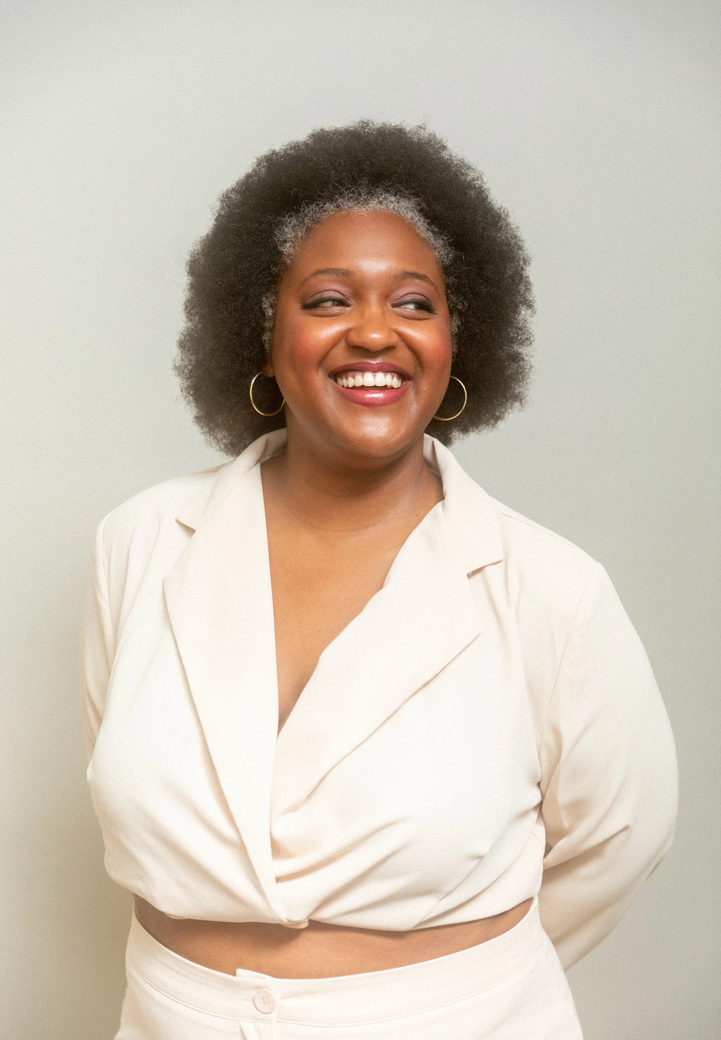 Jenae Thompson, a Fractional CMO and marketing strategist, smiling for a professional brand headshot.