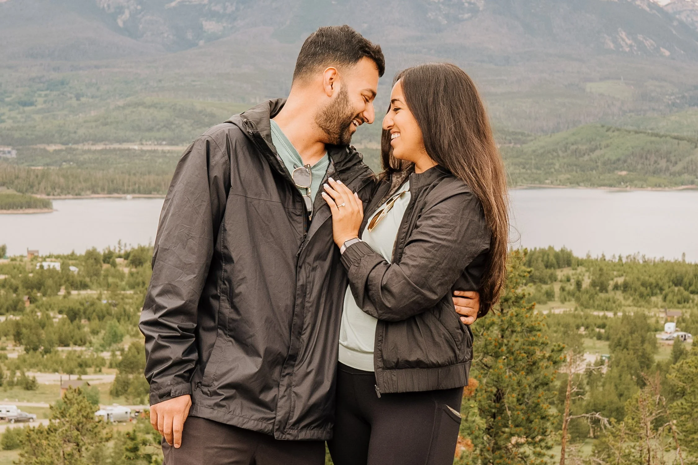 Just engaged couple smiling at each other in a sweet pose.