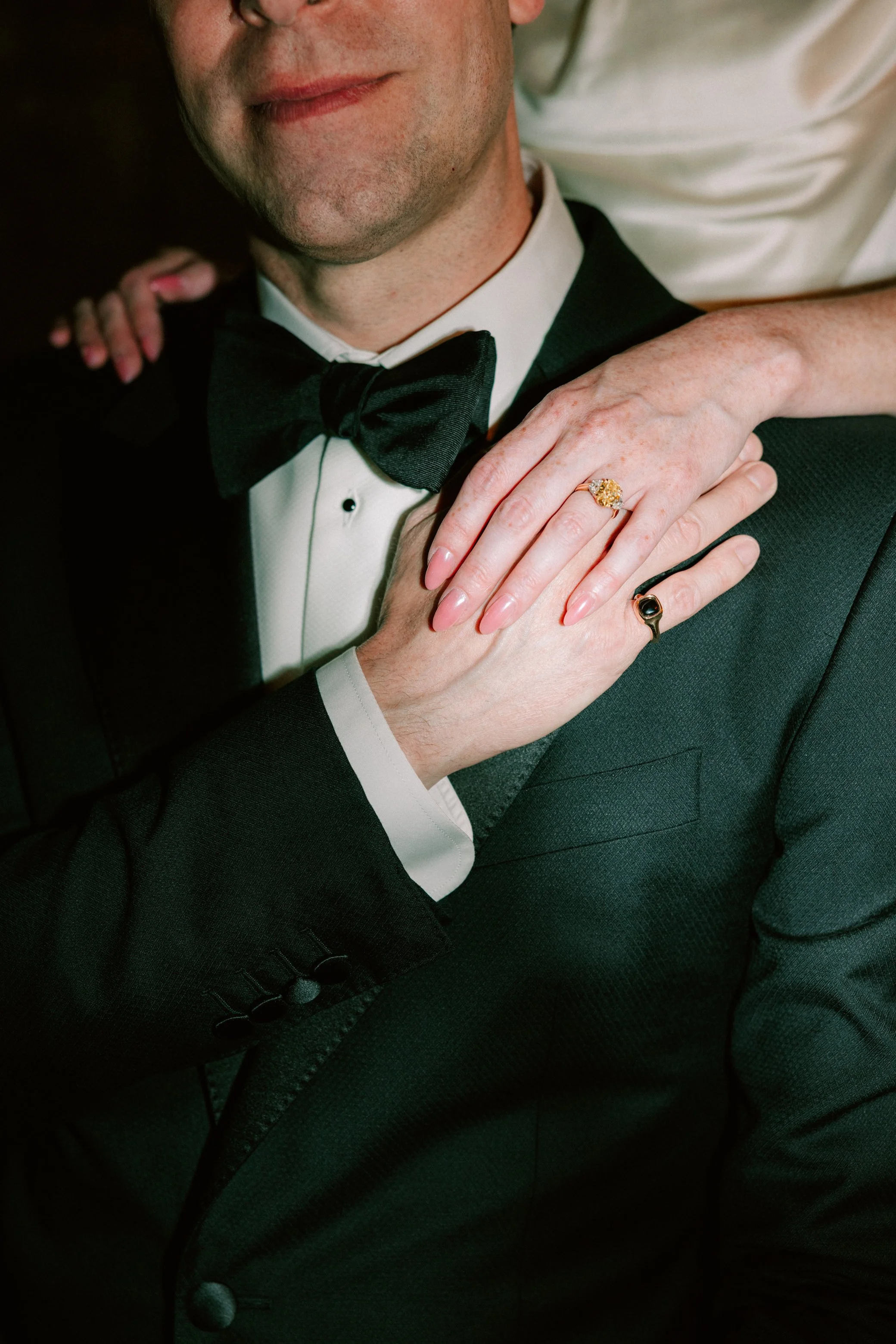 bride resting hand on grooms shoulder in senate garage