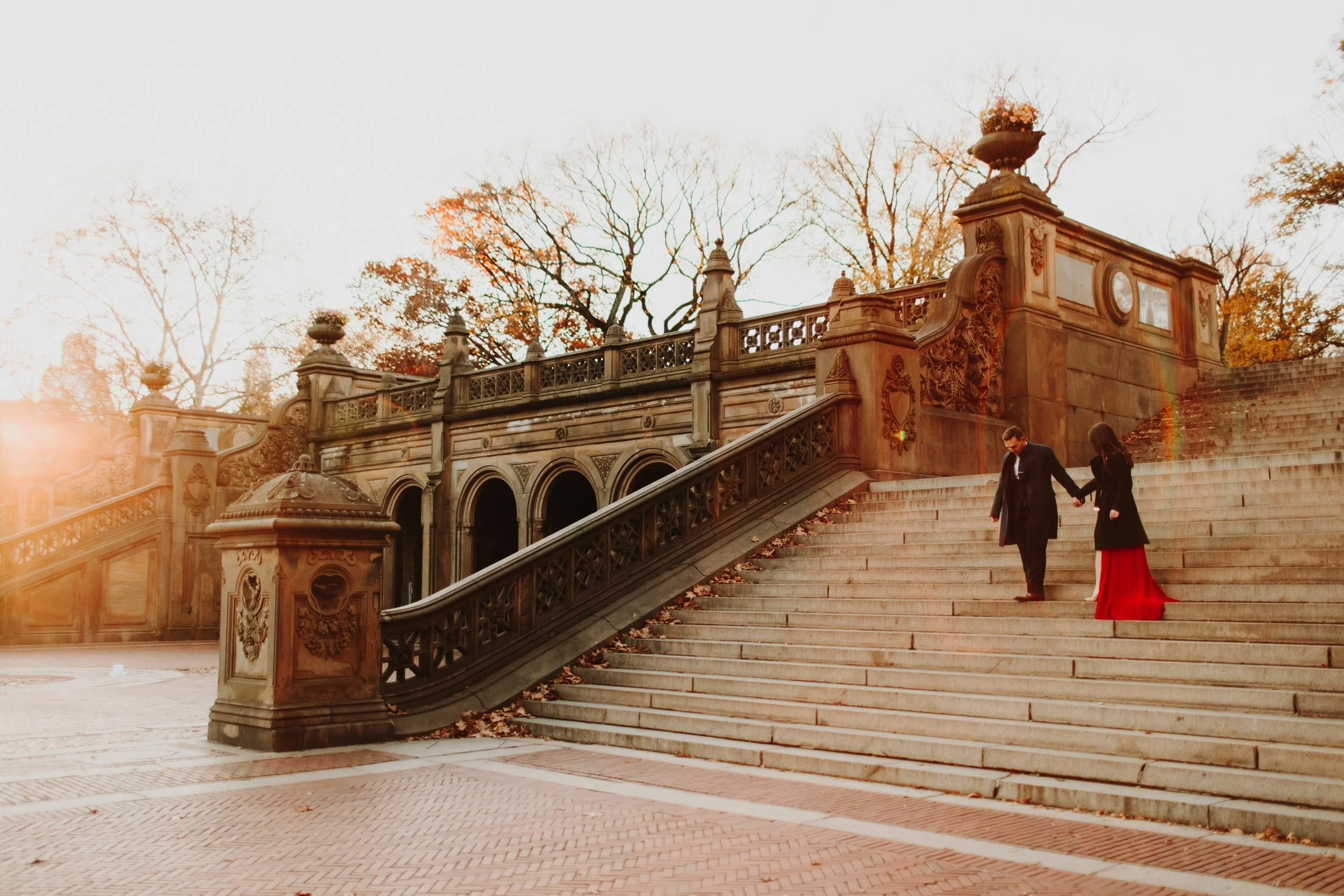 couple on stairs during their sunrise engagement photo shoot in central park