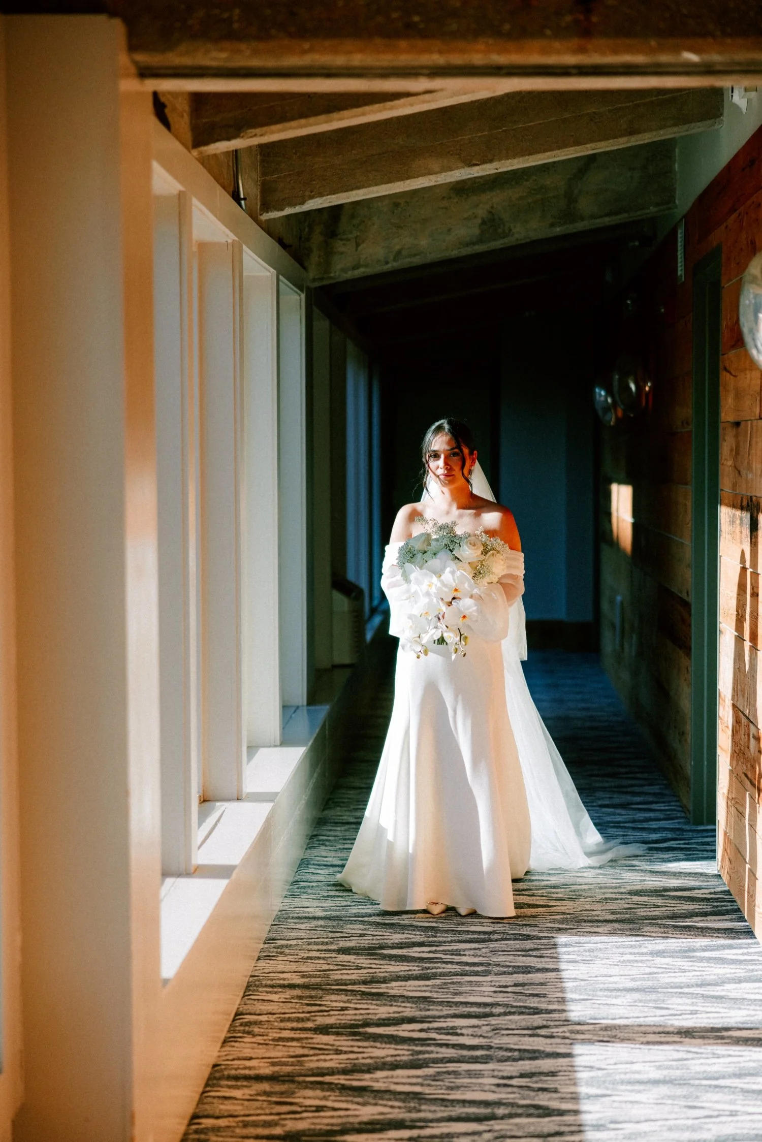 bride in the hallway of the roundhouse on her way to her wedding day first look