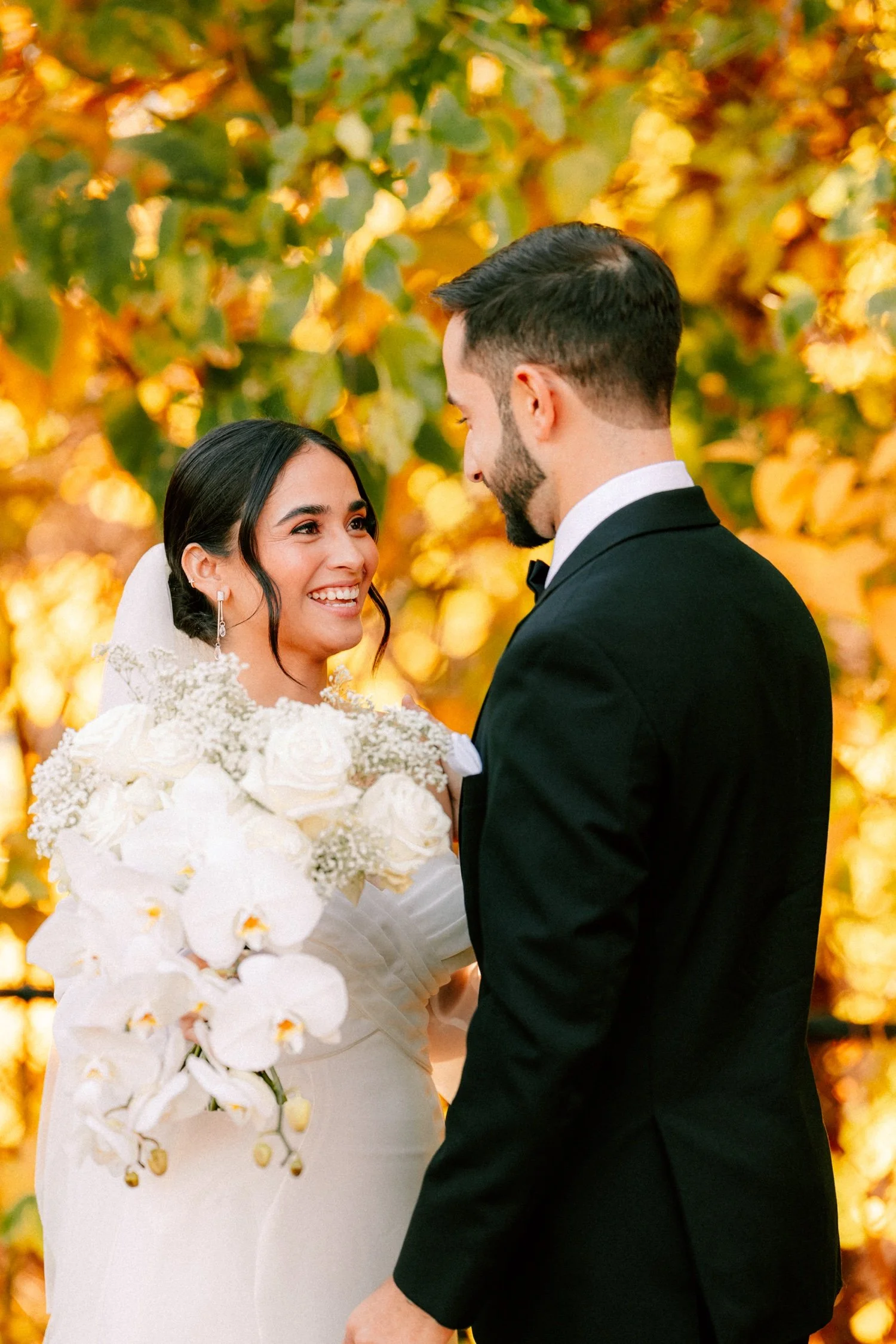 wedding couple laugh and smile with each other during their first look at the roundhouse
