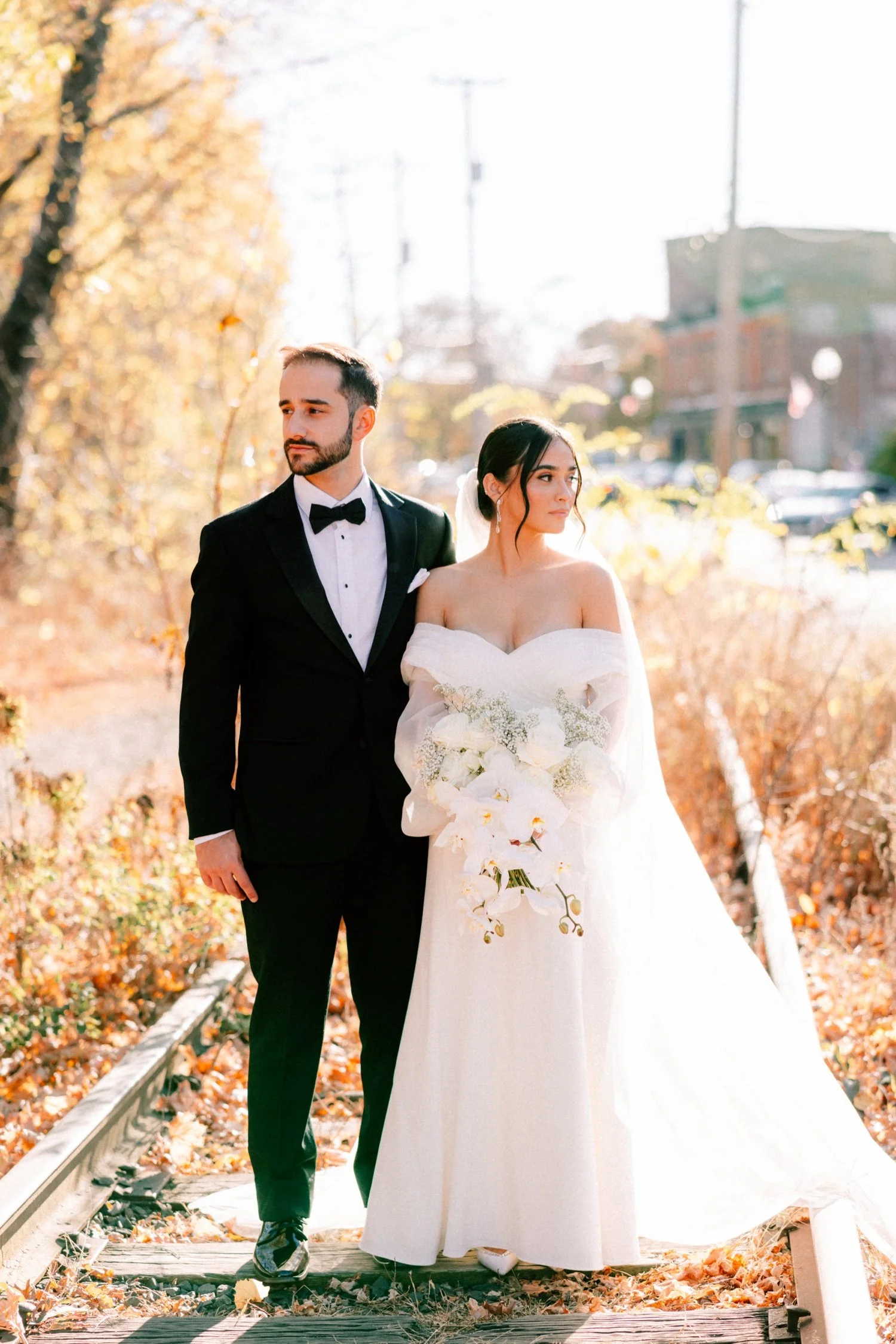 editorial photograph of wedding couple on the train tracks in beacon ny by the roundhouse venue