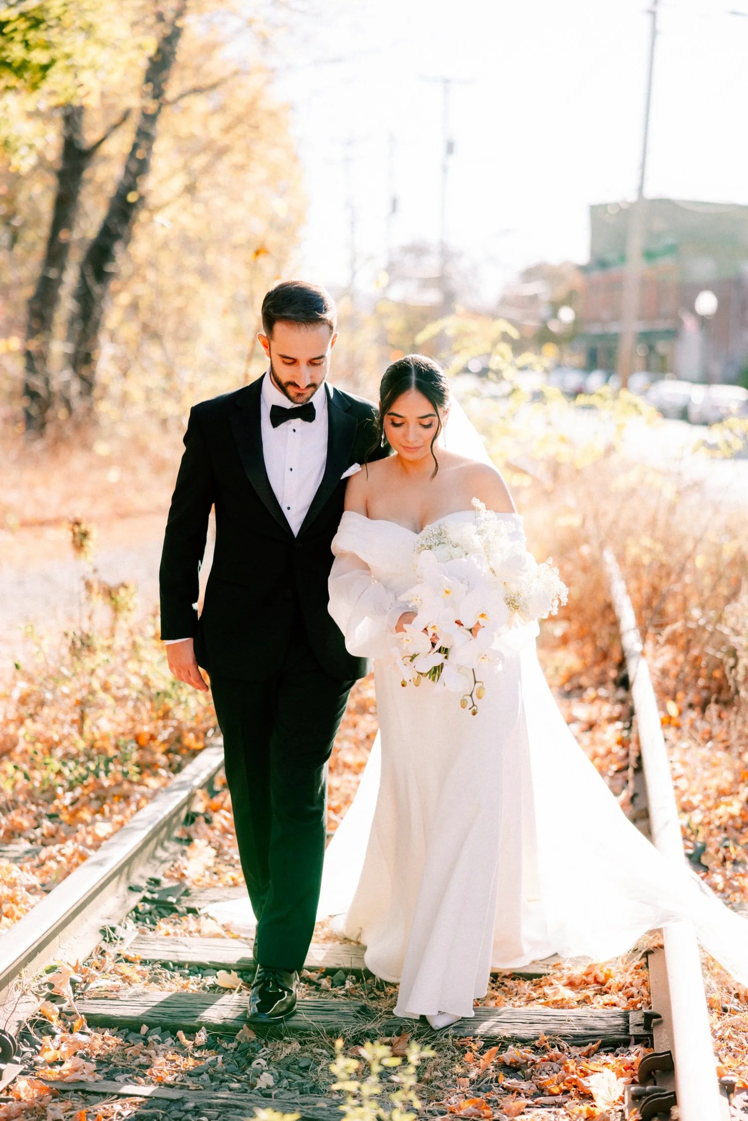 documentary photograph of wedding couple walking down the train tracks in beacon ny