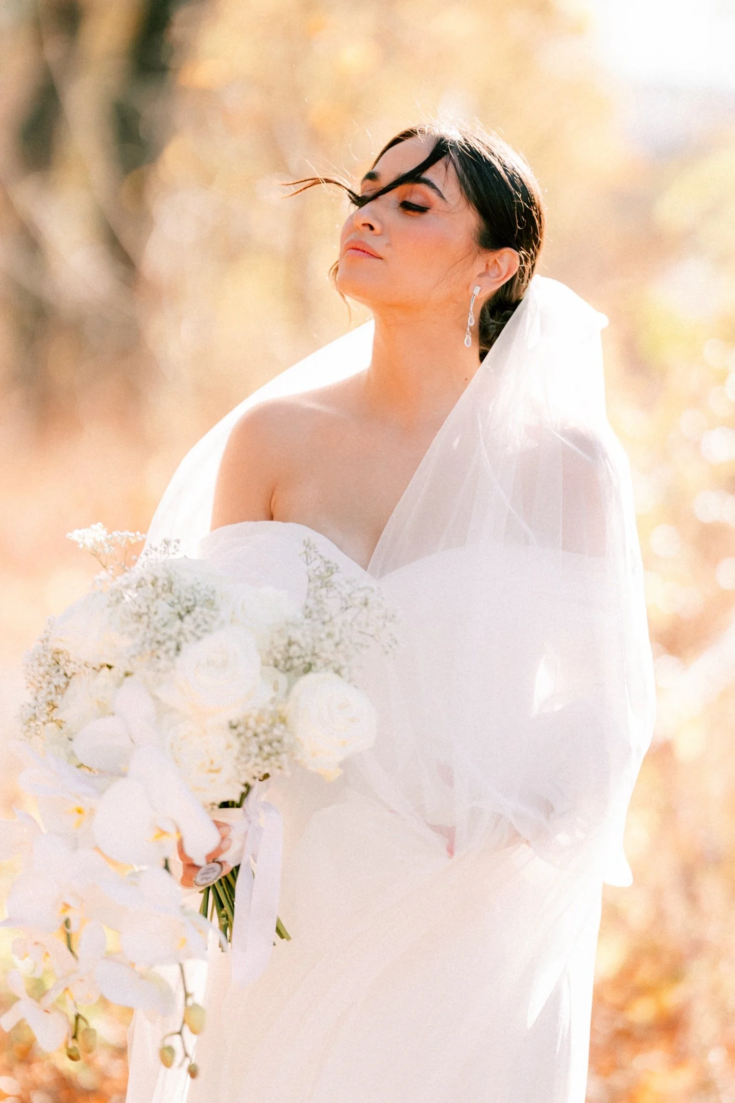 editorial photograph of bride with wind in her hair on her wedding day at the roundhouse
