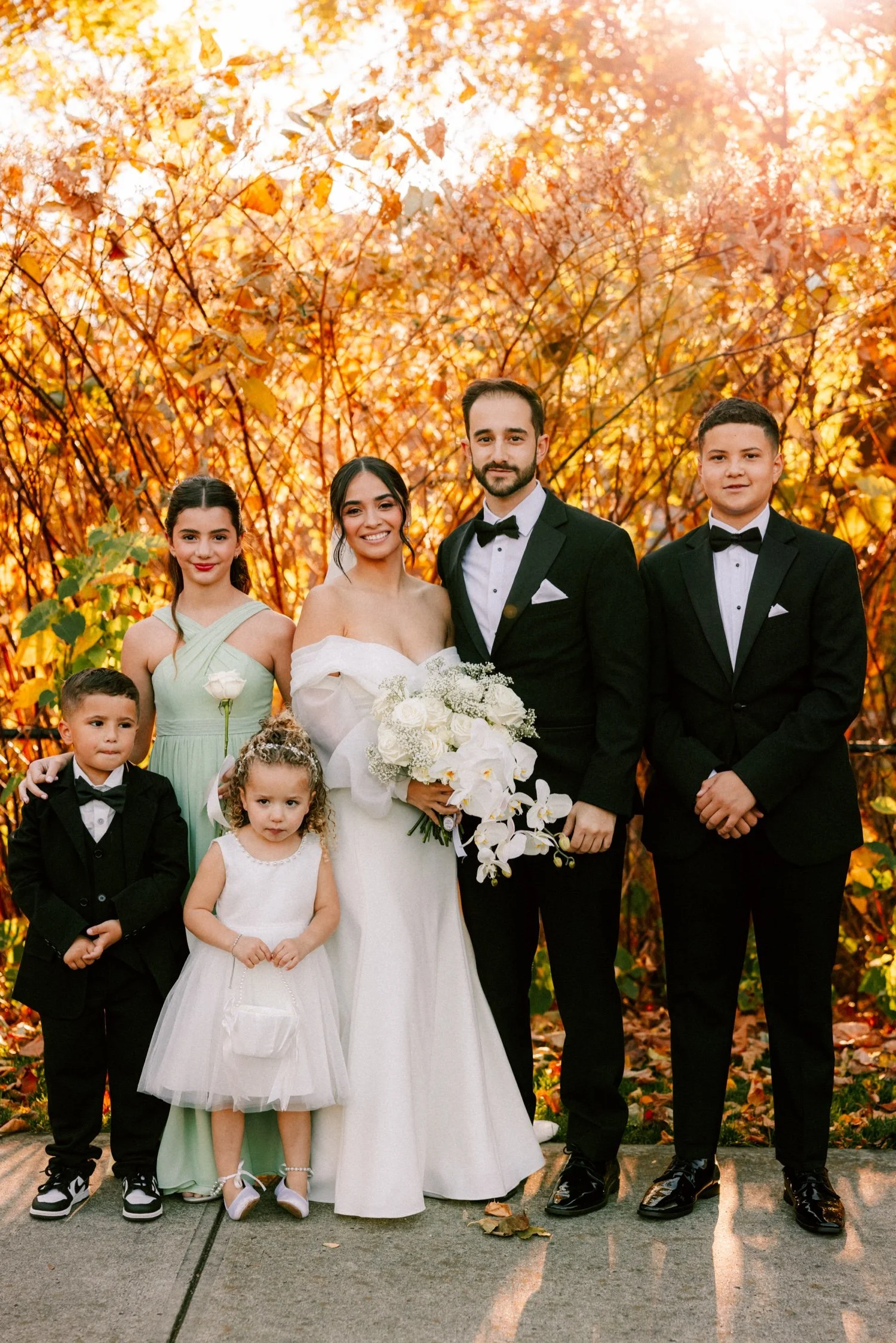 photograph of wedding couple with flower girls and ring bearers on sunny november day at the roundhouse
