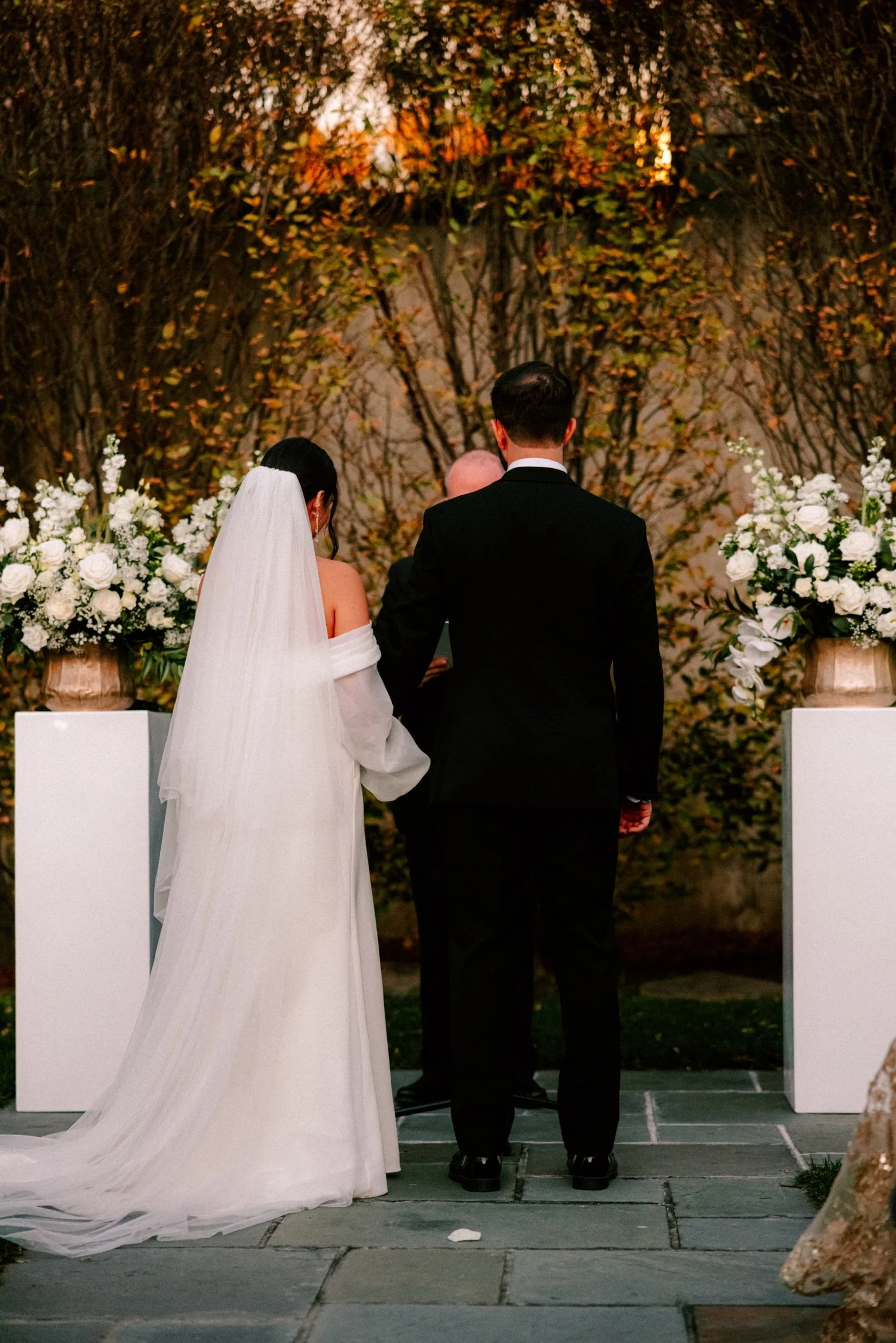 bride and groom hold hands during wedding ceremony at the roundhouse