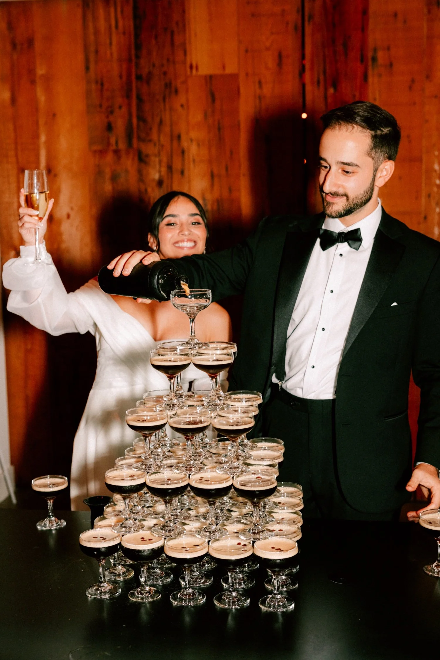 bride and groom pouring espresso martinis during cocktail hour at the roundhouse