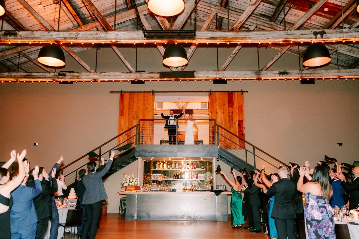 bride and groom grand introduction through barn doors during reception at the roundhouse