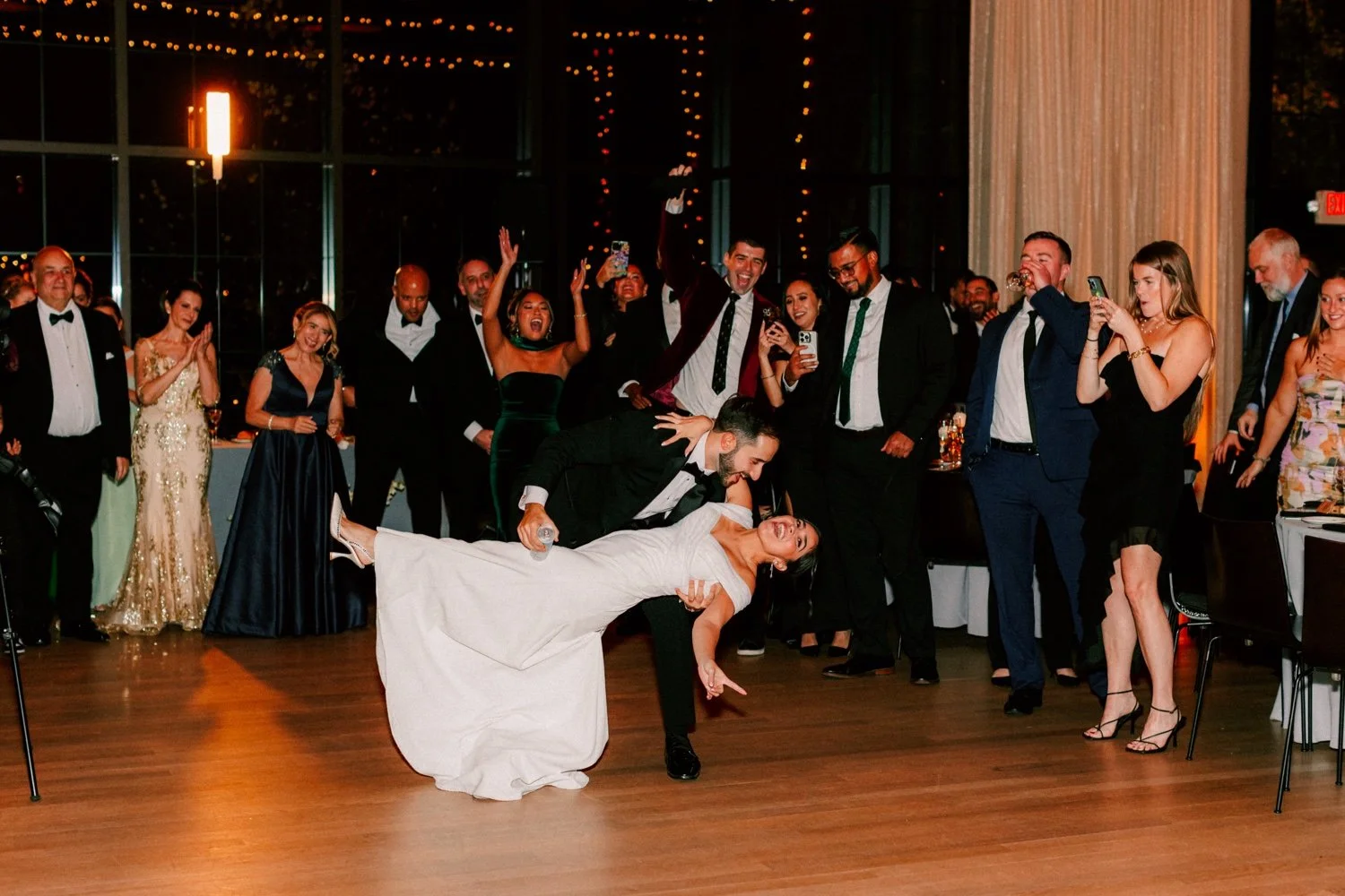 groom dips bride during their wedding day first dance at the roundhouse