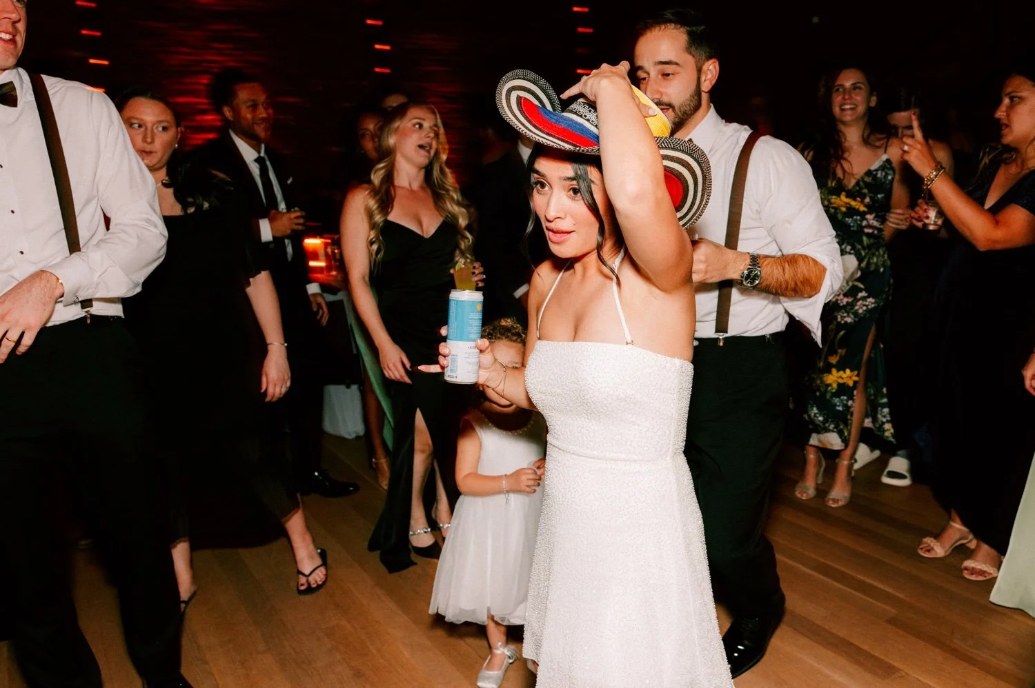 bride wears fun hat during wedding reception at the roundhouse
