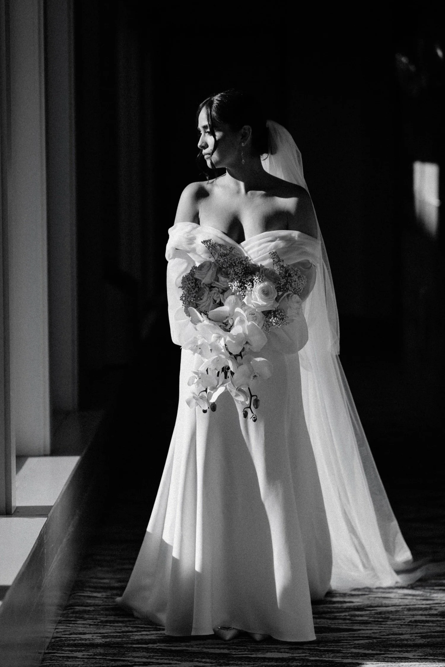 black and white documentary photograph of bride on her way to her first look on wedding day at the roundhouse