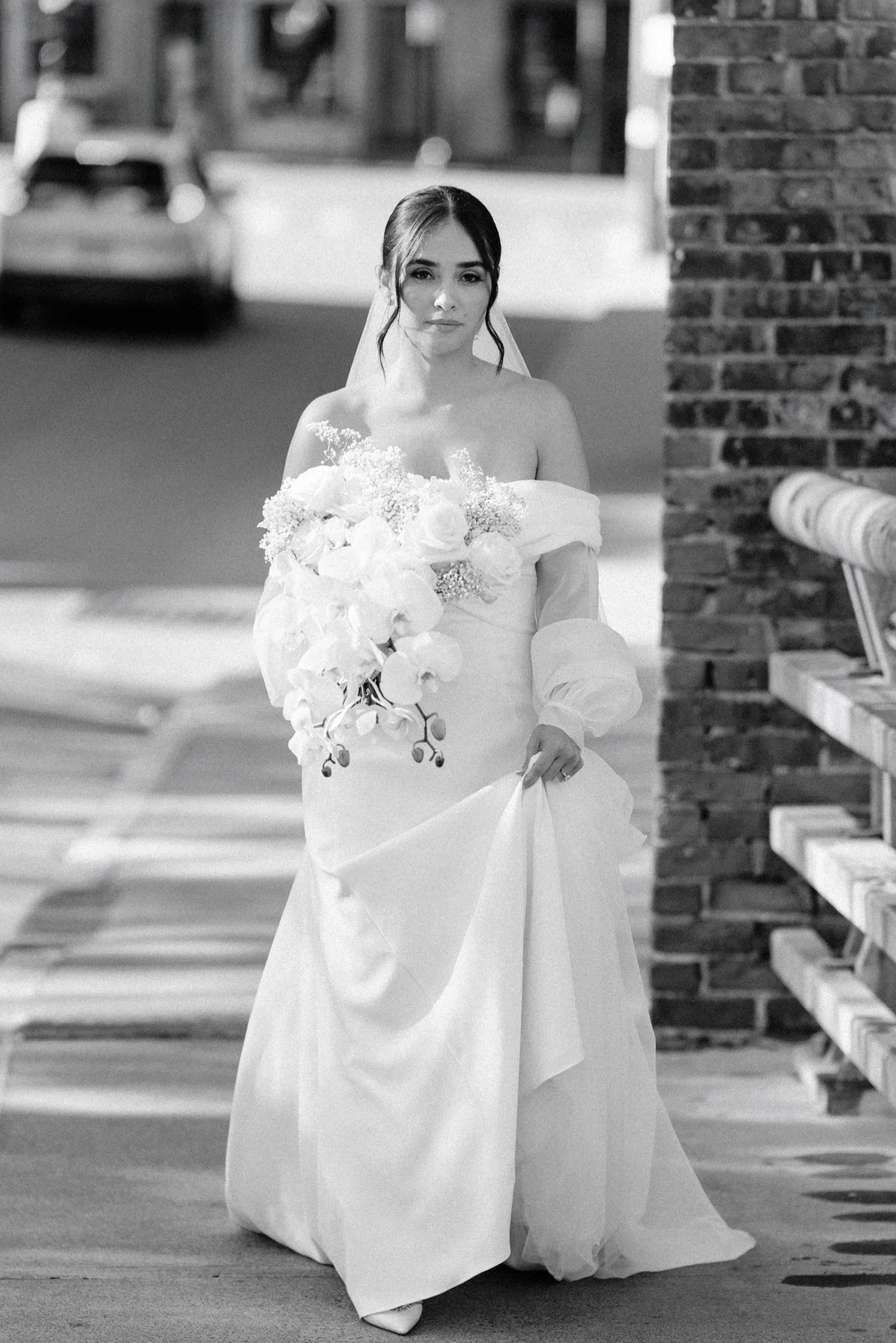documentary black and white photograph of bride walking to her first look at the roundhouse