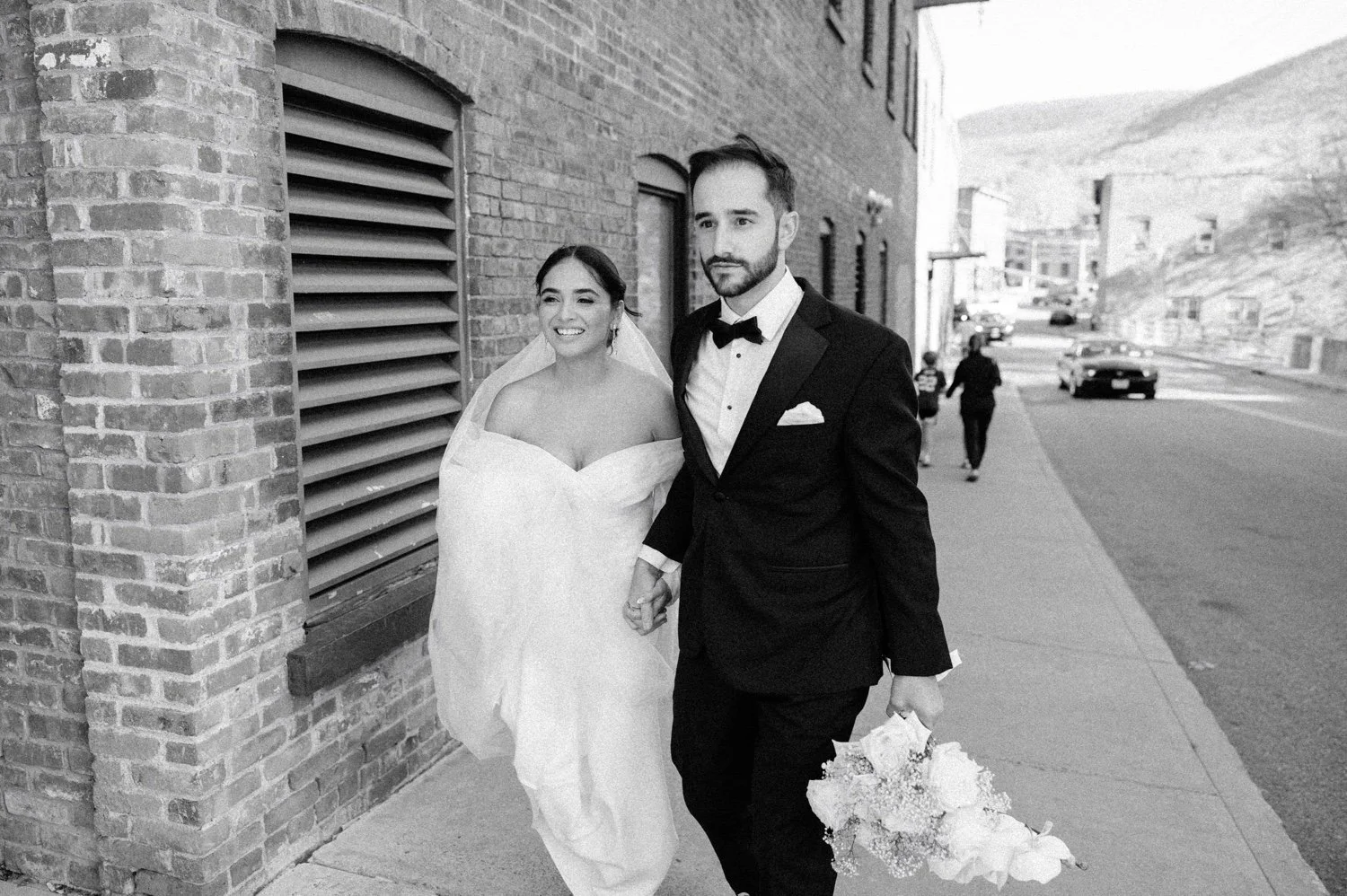 documentary black and white photograph of wedding couple walking down street in beacon