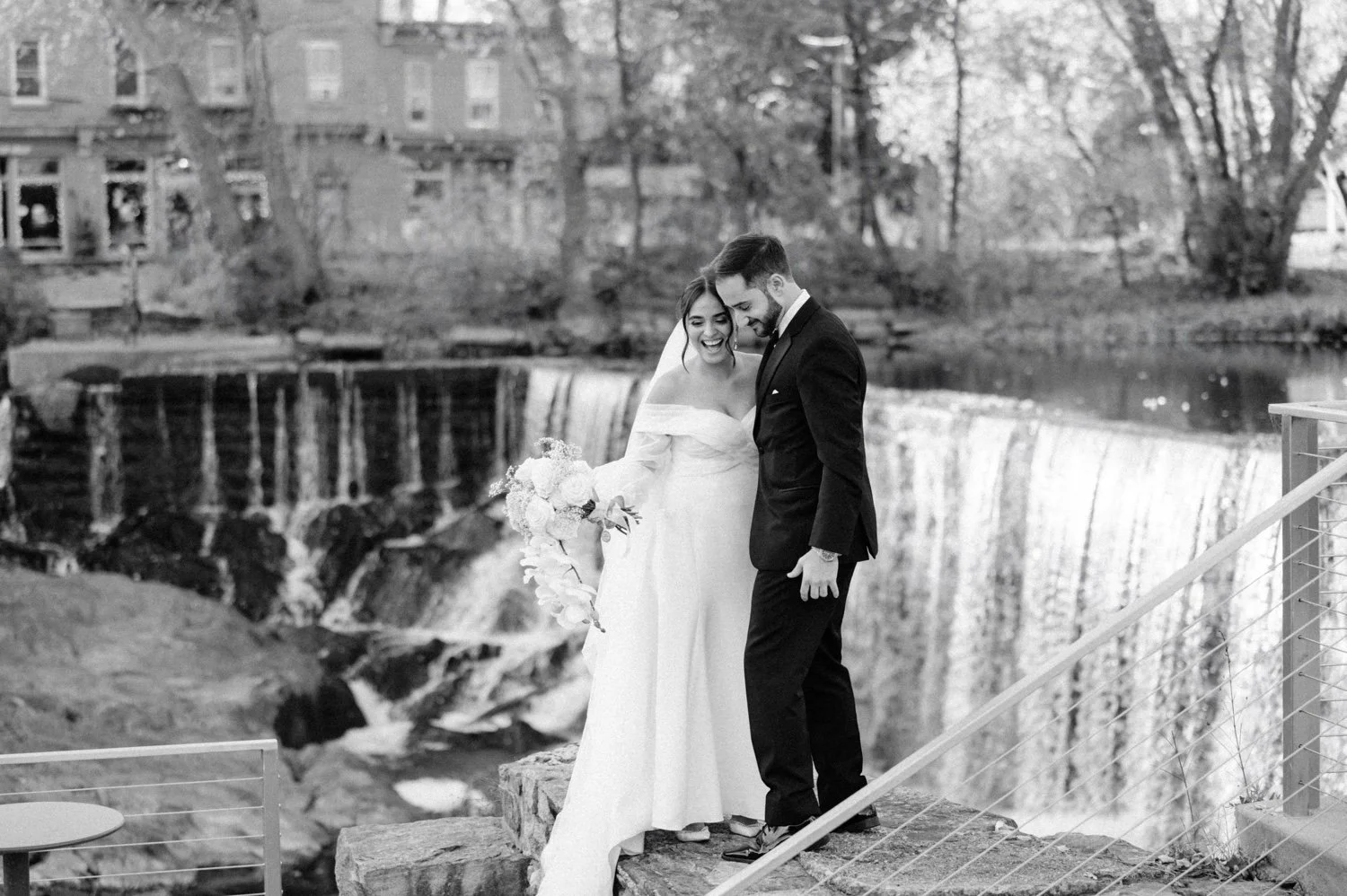 black and white photograph of bride and groom in front of beacon falls on their november wedding day at the roundhouse