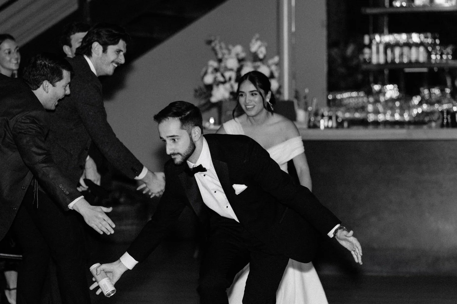 bride and groom give high fives to guests during reception introduction at the roundhouse