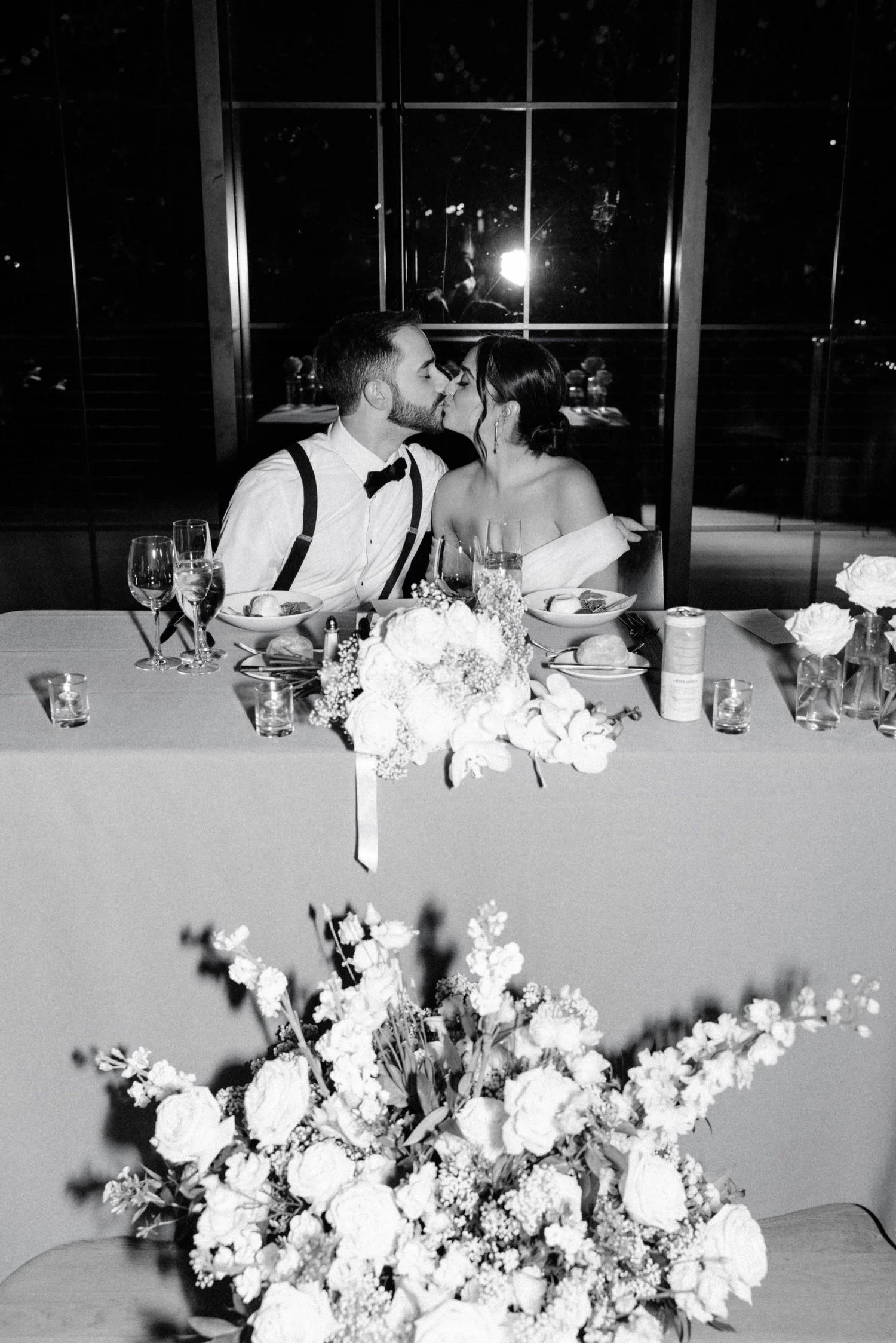 black and white photograph of couple at their sweetheart table during wedding reception at the roundhouse