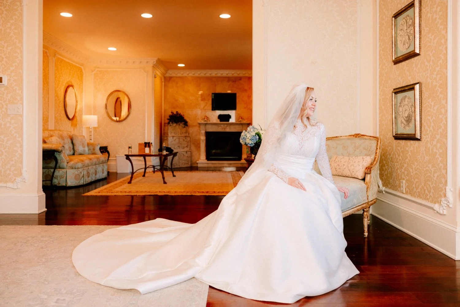 timeless portrait of bride sitting on chaise lounge on her winter wedding day at the ashford estate