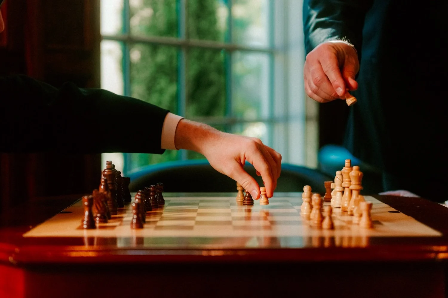 detail of groom and son’s hand playing chess at the ashford estate