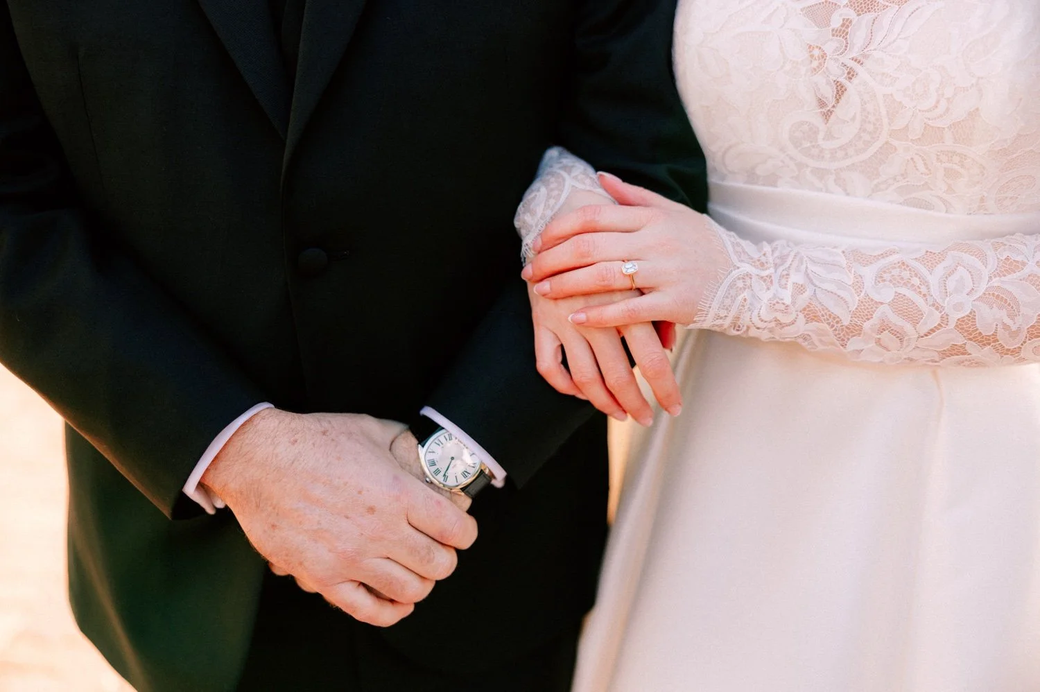 photograph of bride and groom’s hands on their winter wedding day at the ashford estate