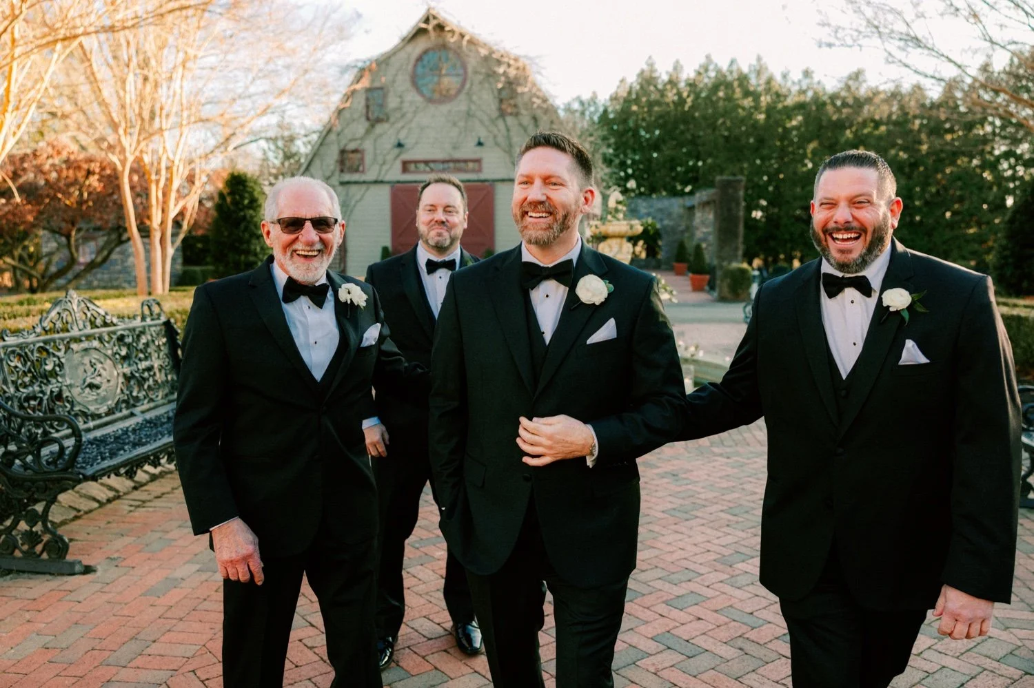 documentary wedding photographs of groom and groomsmen walking at the ashford estate