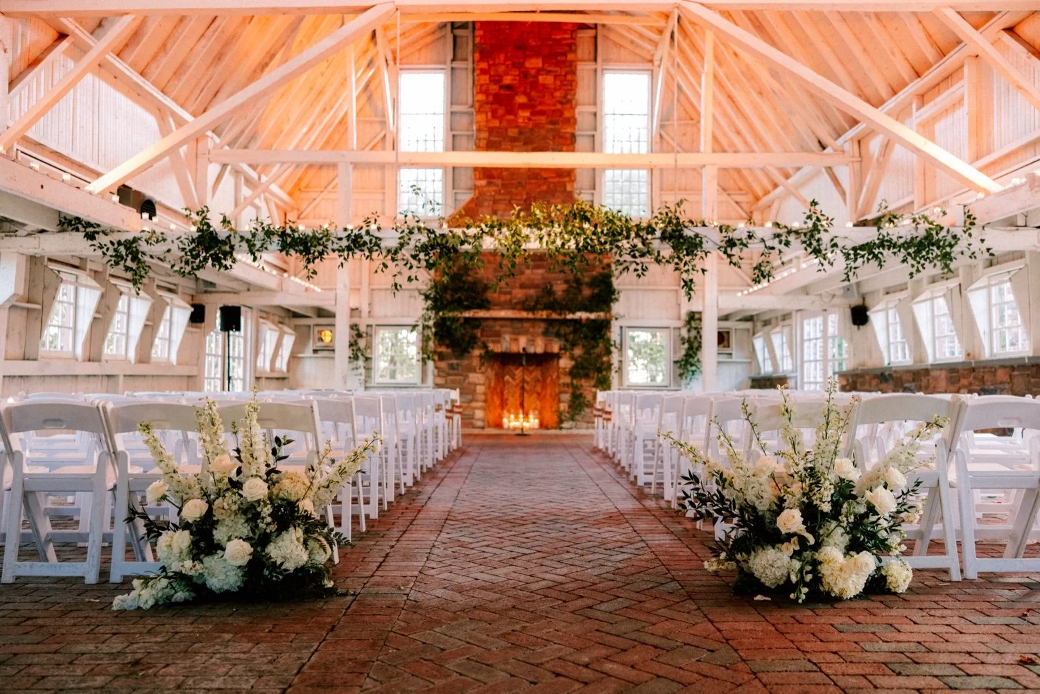 barn wedding ceremony filled with candlelight for winter wedding day at the ashford estate