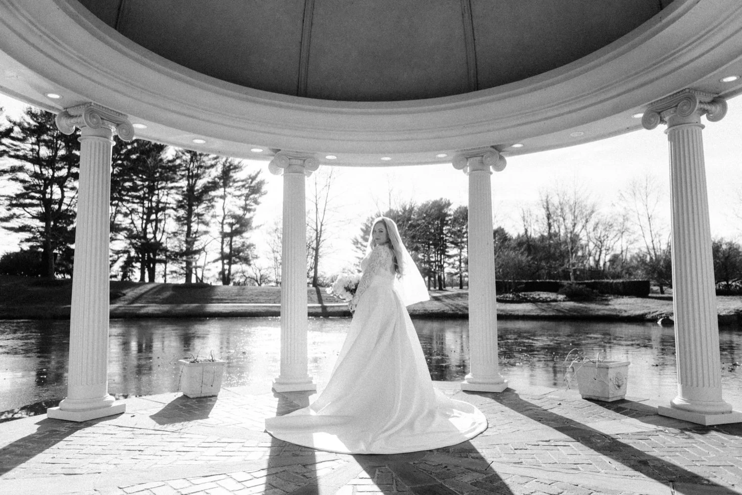 documentary black and white photograph of bride under gazebo