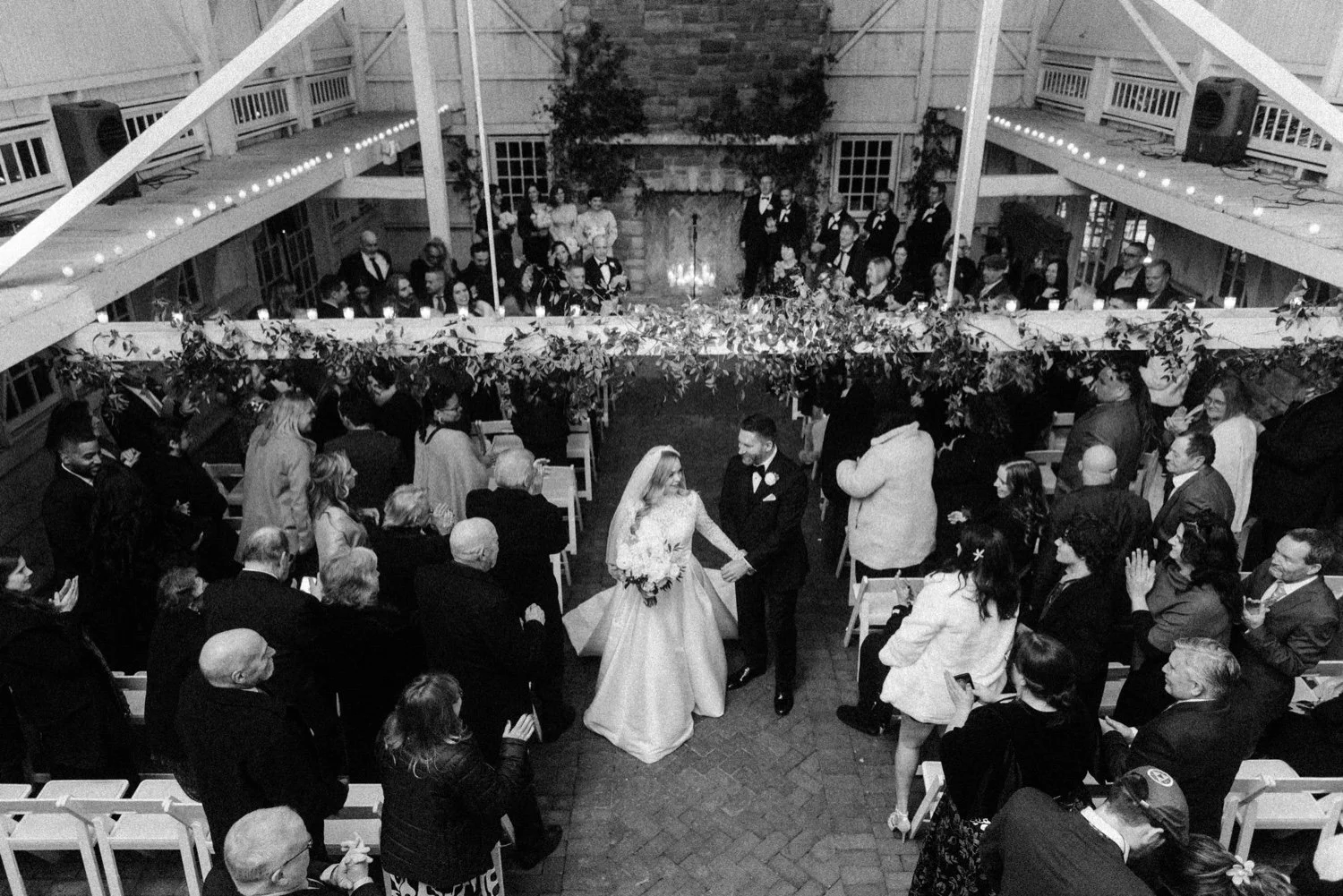 bride and groom just married walking down aisle in the barn at the ashford estate