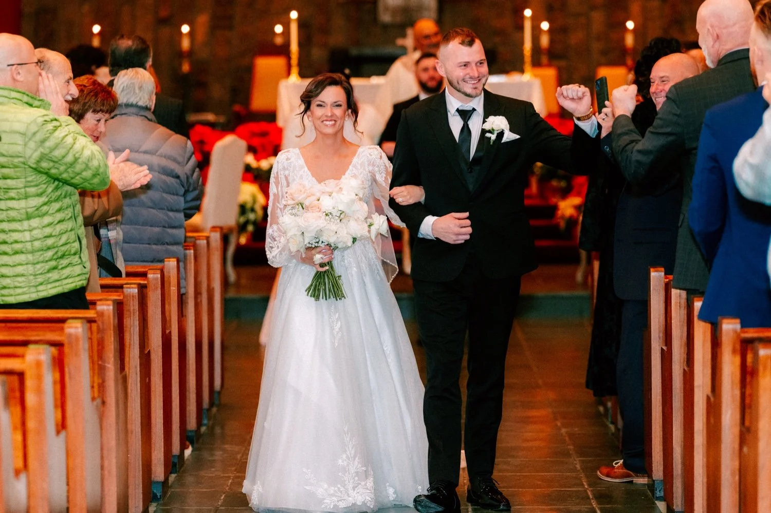  couple just married walking down aisle during recessional in church 