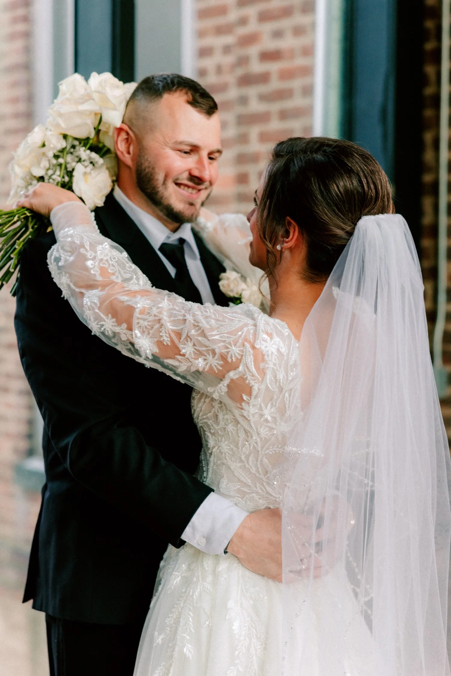  bride and groom looking at each other with arms around each other on their winter wedding day at city winery hudson valley  