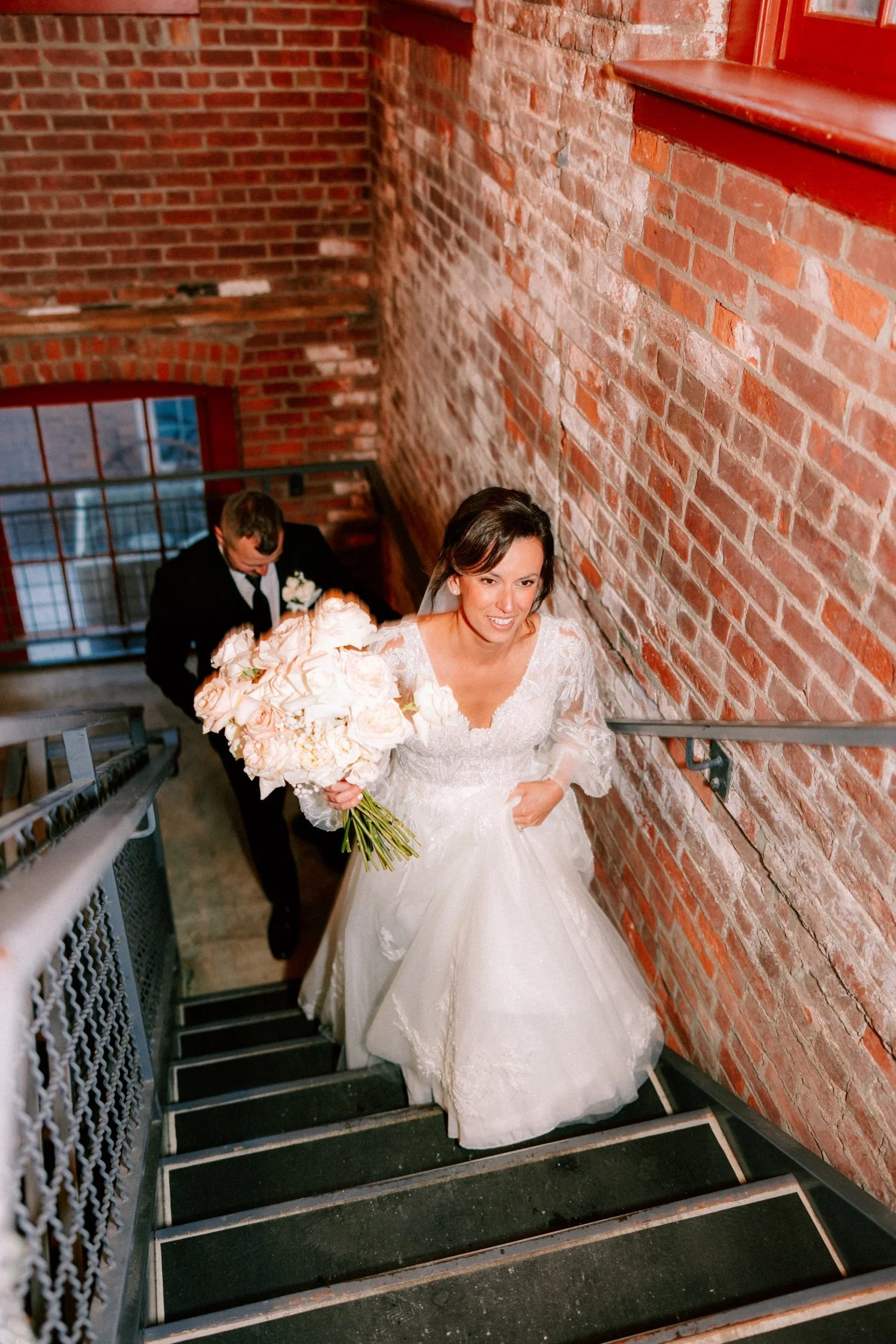  winter wedding couple walking up stairs at city winery hudson valley 