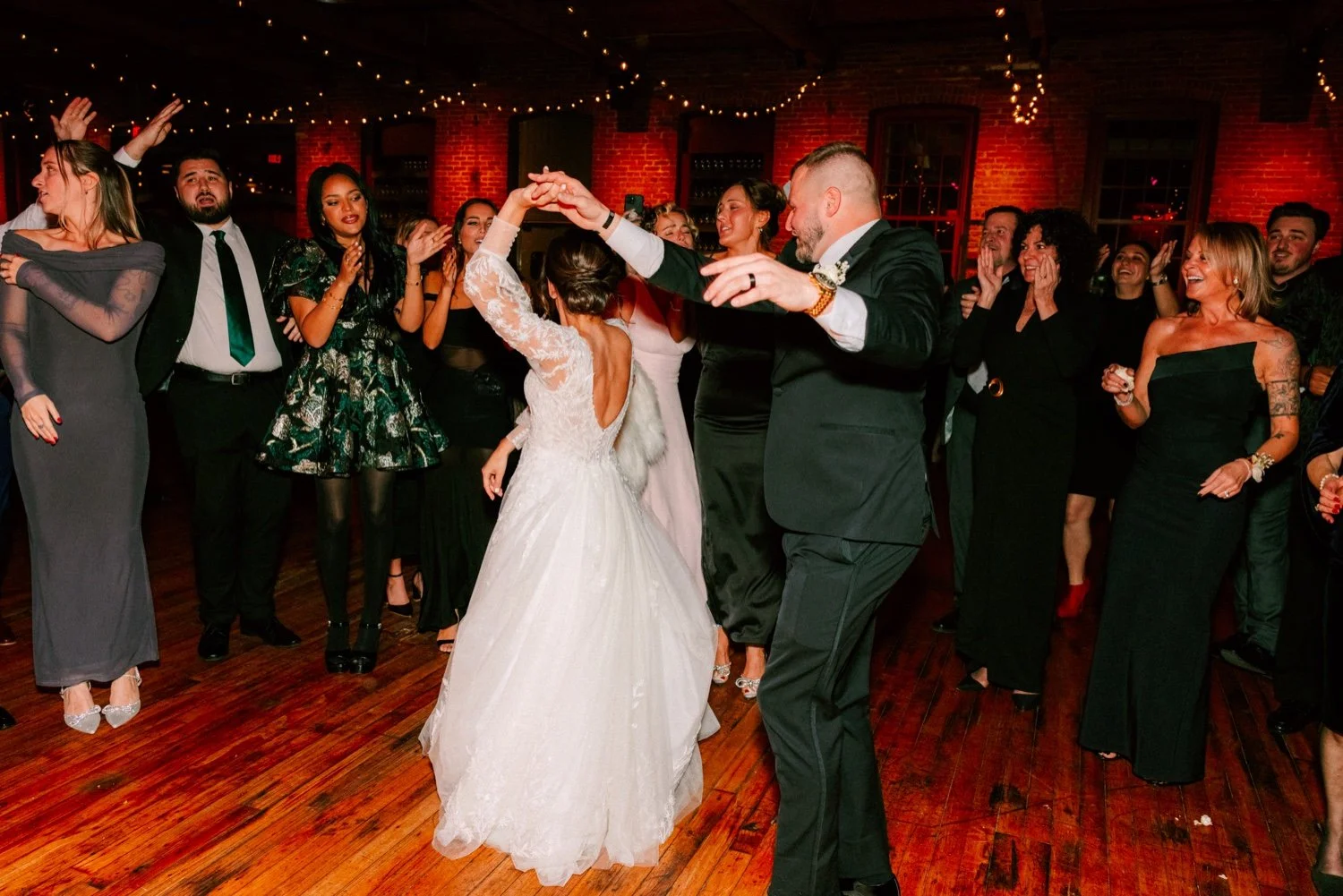  groom spins bride on the dance floor during winter wedding reception at city winery hudson valley 