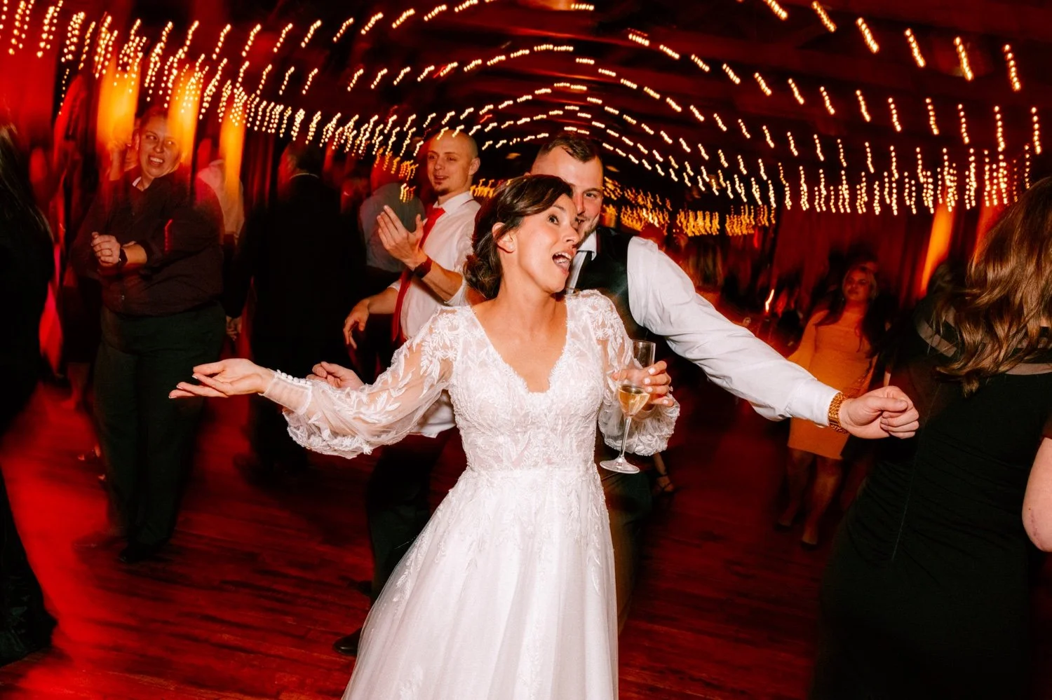  bride and groom dancing during their wedding reception at city winery with motion blur and string lights 
